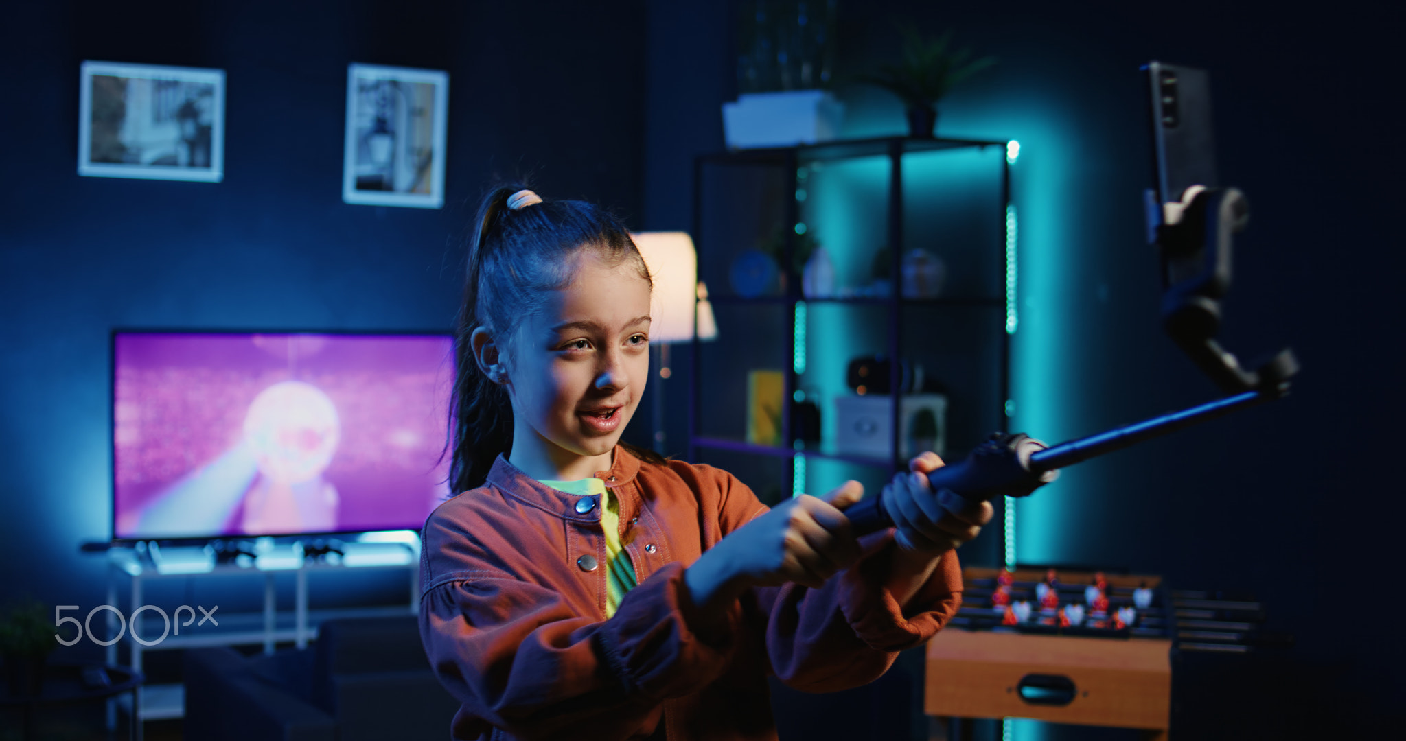 Focus shot on smartphone on tripod used by kid in blurry background