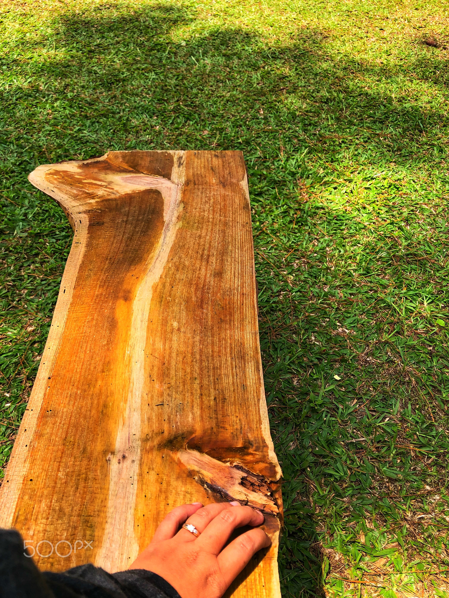 Hands on a wooden chair in the park