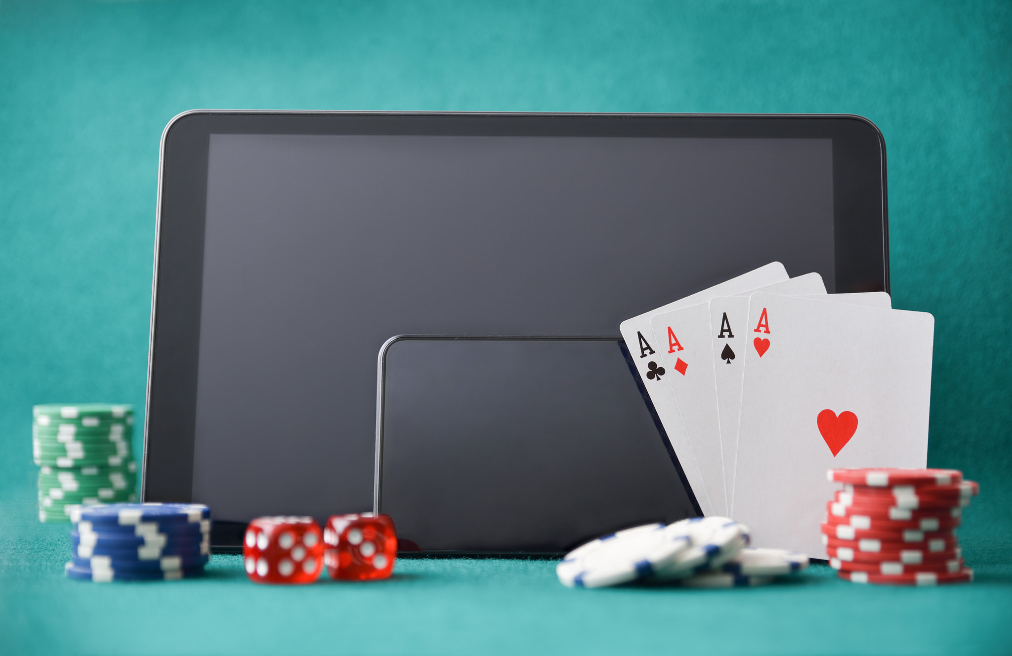 Electronic devices for online casino gaming on green background