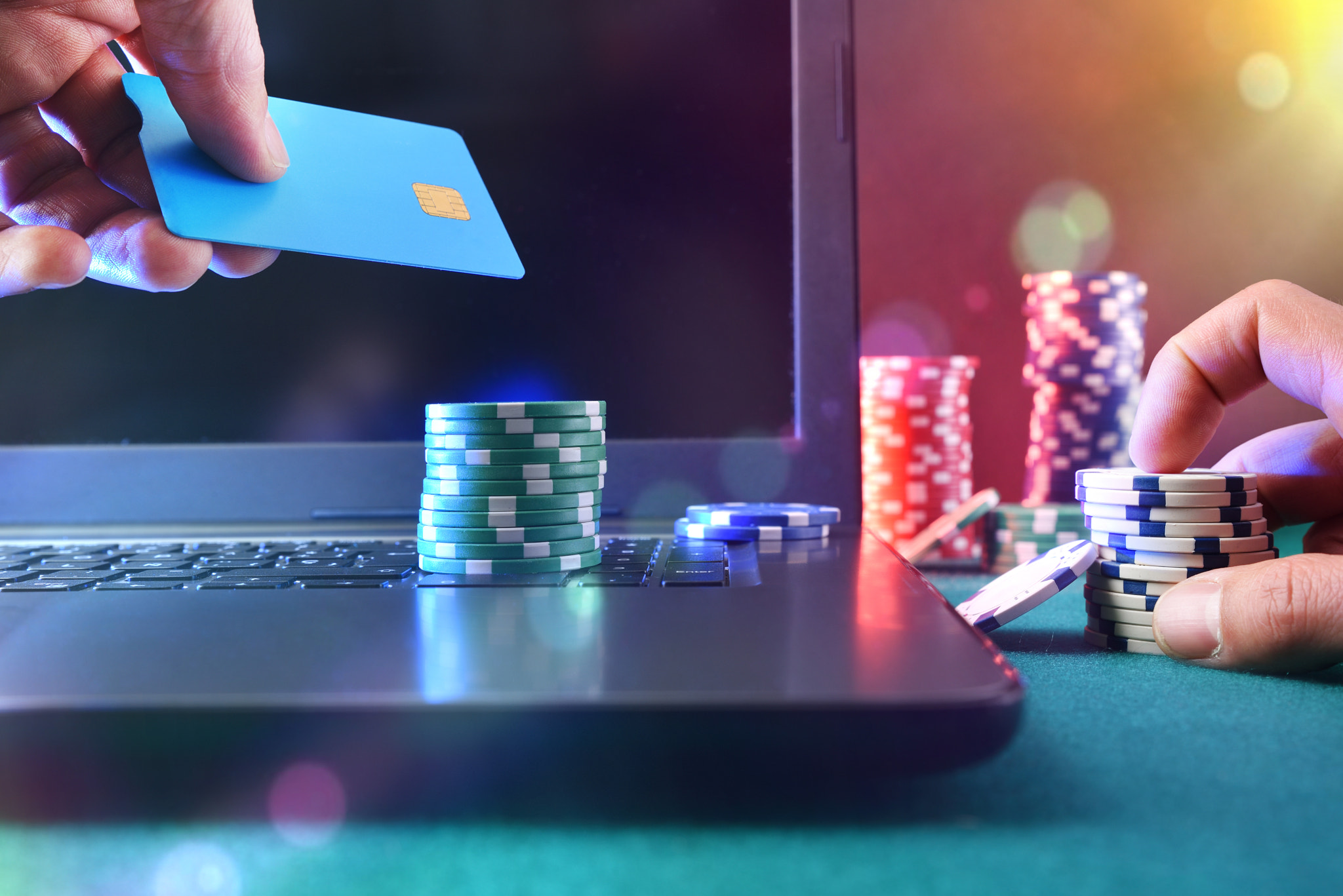 Casino game player betting online with laptop