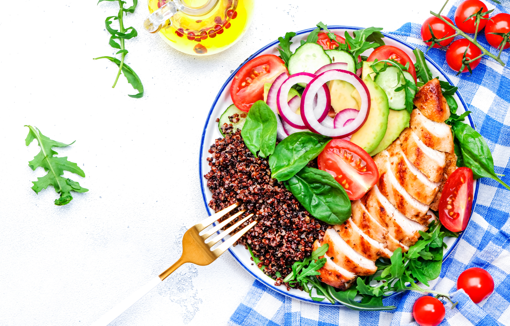 Grilled chicken meat, red quinoa healthy salad with tomatoes, avocado, arugula and spinach. Detox,