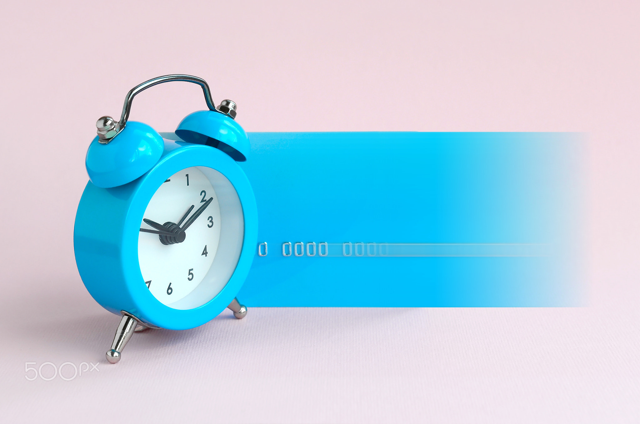 Small blue alarm clock and blue credit card