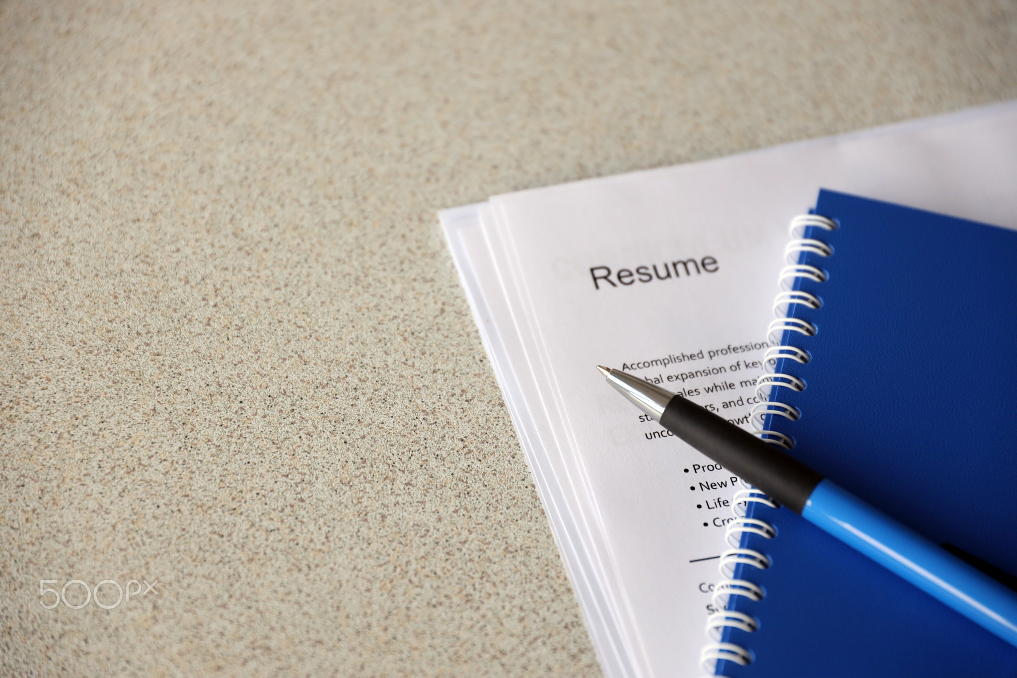 Top view of stack of office documents including resume and cv forms on the desk close to pen and