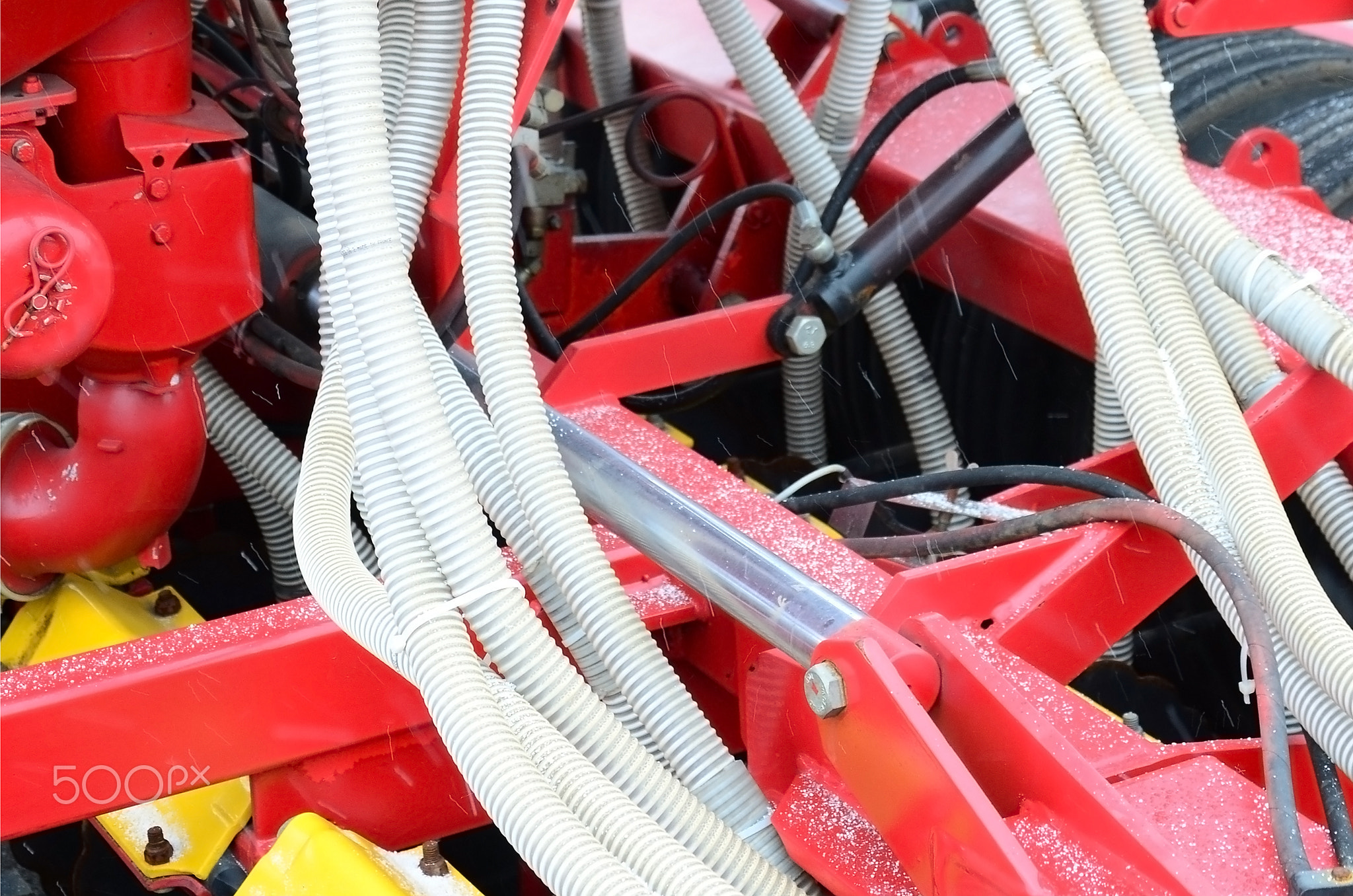 Springs and tubes are arranged in a row. A row of seeder. Heavy equipment on agricultural exhibition