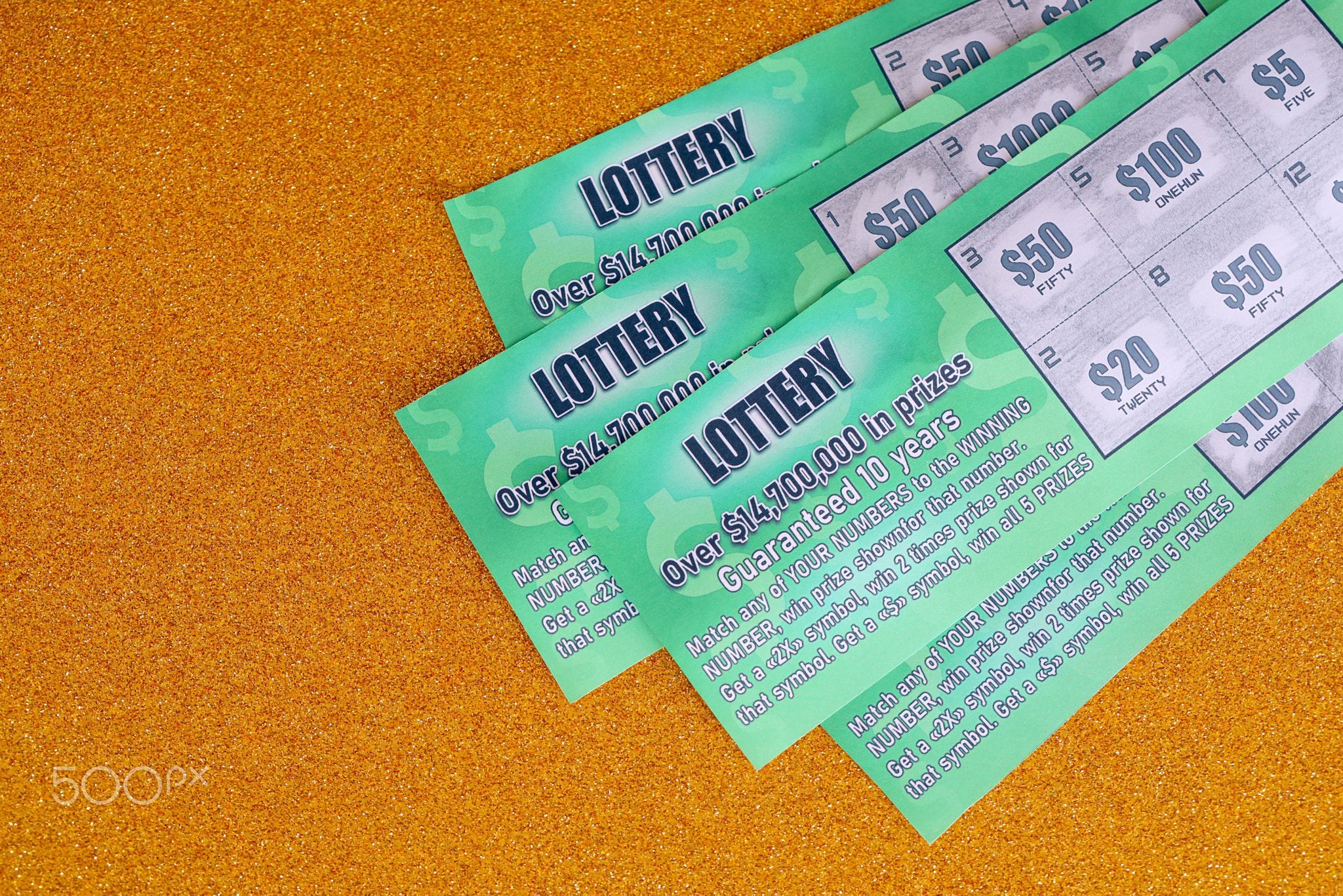 Close up view of green lottery scratch cards. Many used fake instant lottery tickets with gambling