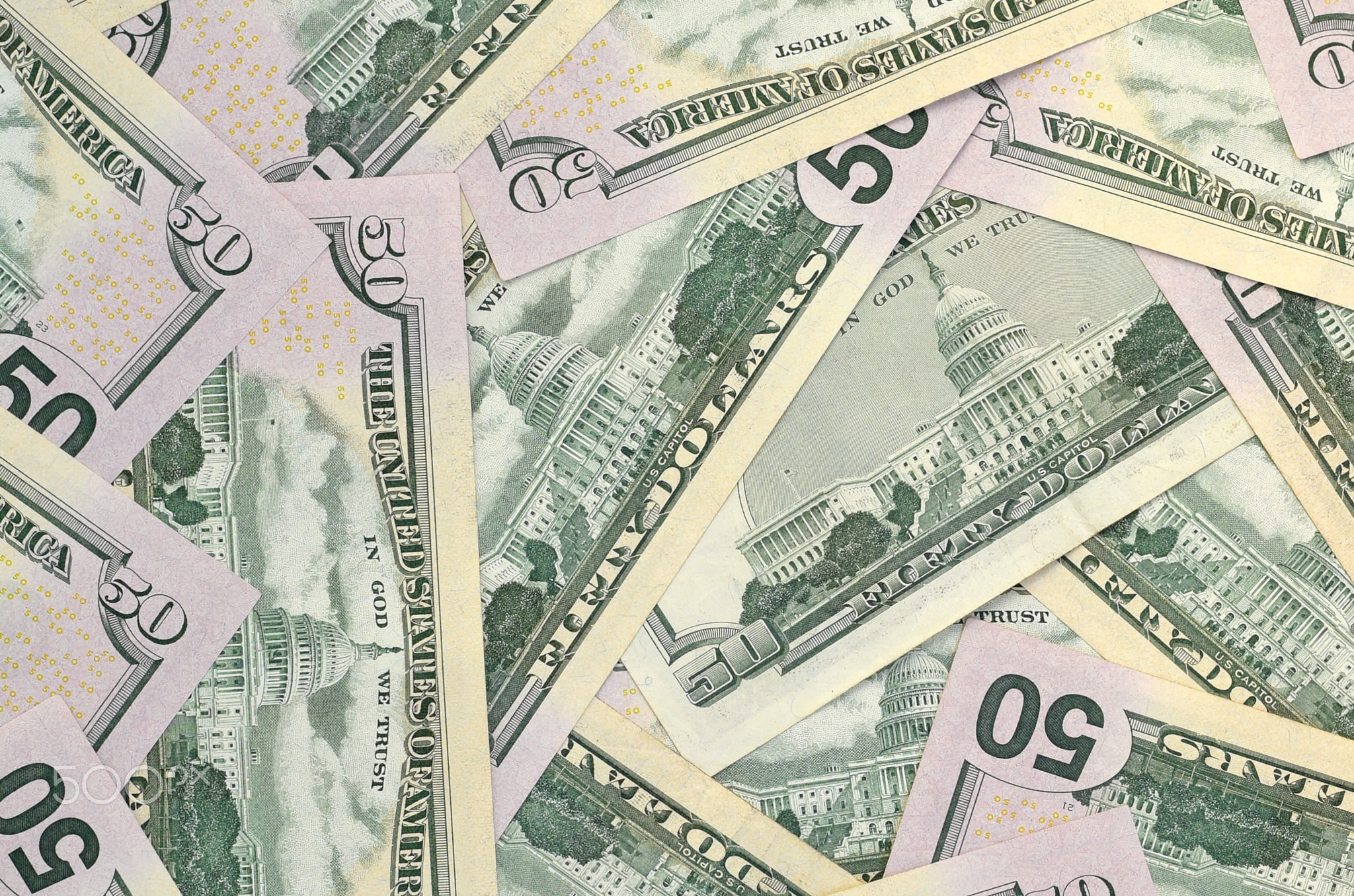 Many US fifty dollar bills on flat background surface close up. Flat lay top view. Abstract business