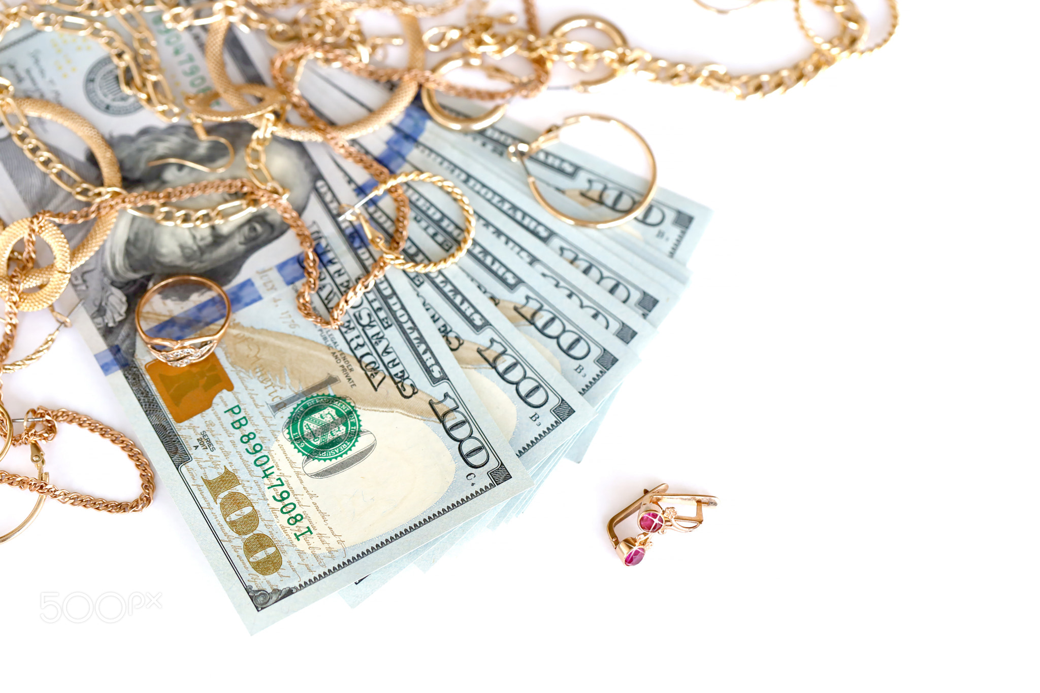 Many expensive golden jewerly rings, earrings and necklaces with big amount of US dollar bills on