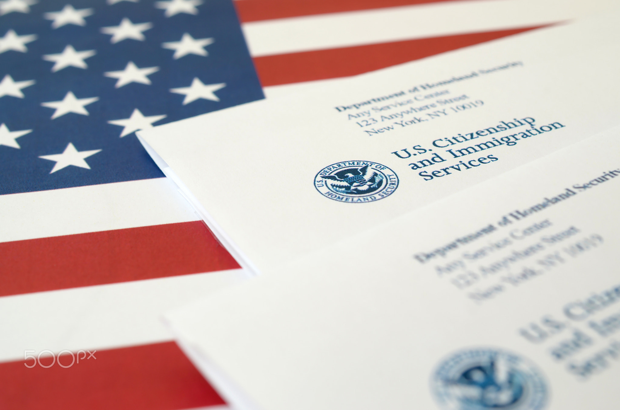 Envelopes with letter from USCIS on United States flag from Department of Homeland Security