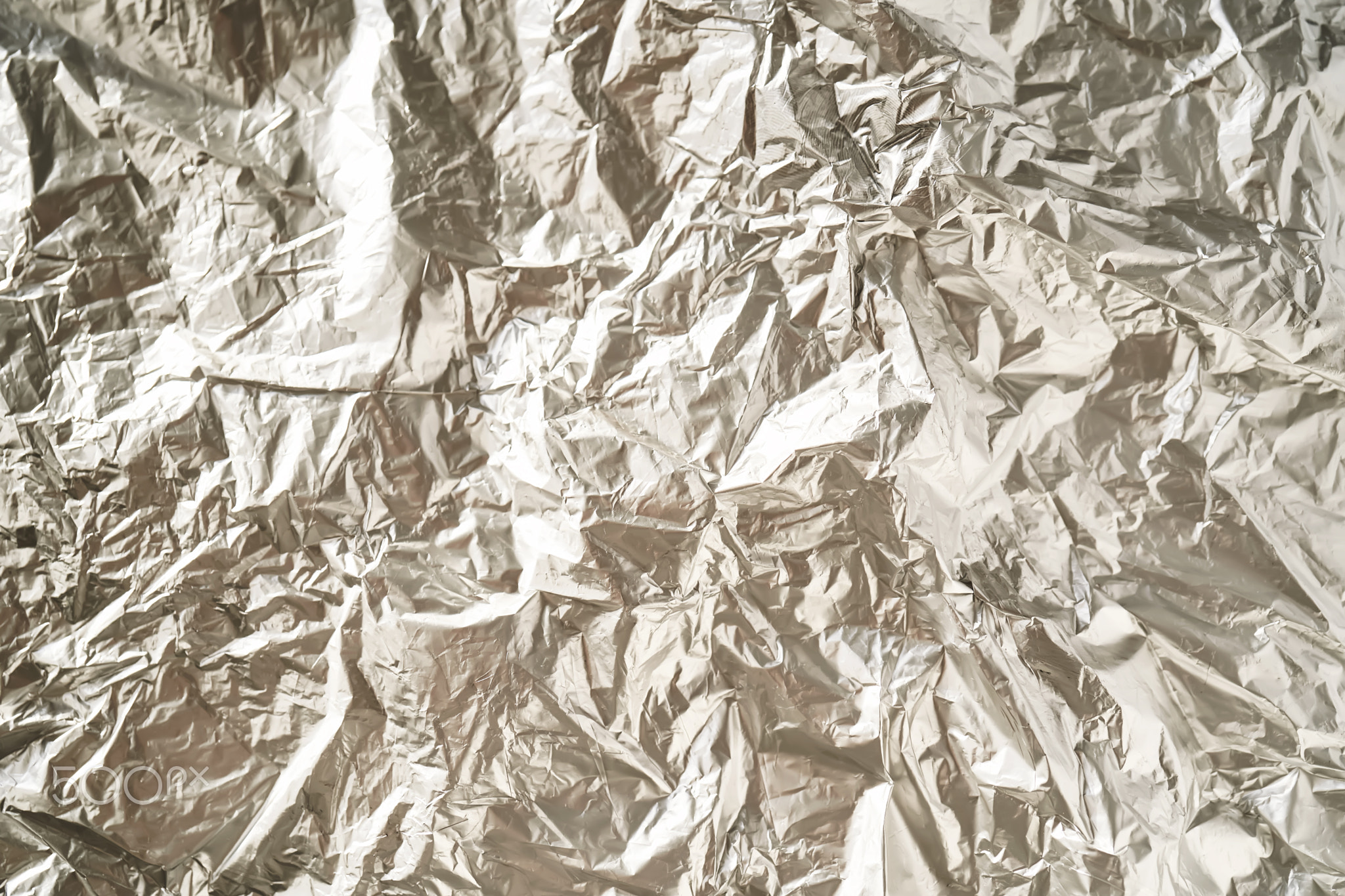 Abstract background made of crumpled silver foil.