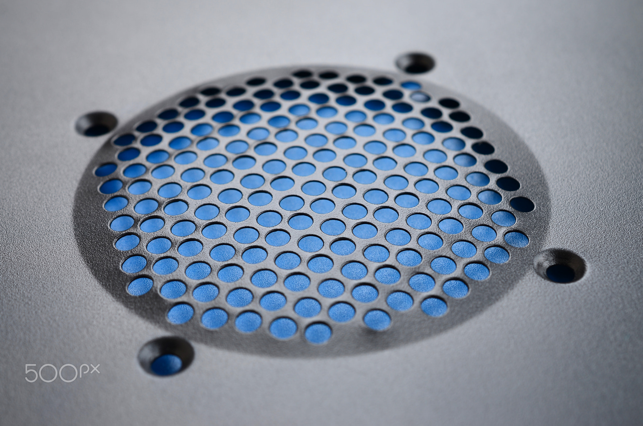 Close-up, shallow focus of a meshed style cooling panel used on a main frame computer. The circular