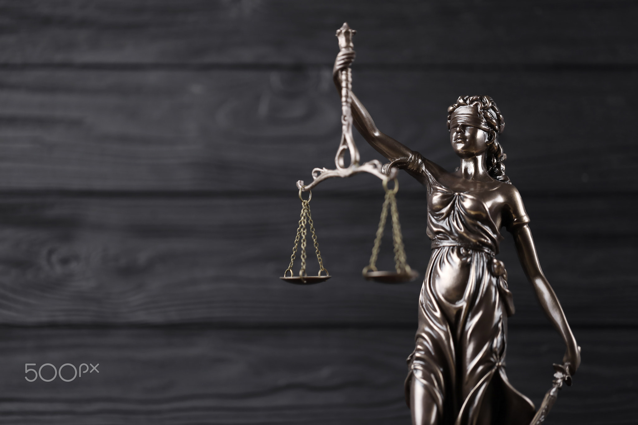 The Statue of Justice - lady justice or justitia the Roman goddess of Justice. Statue on black