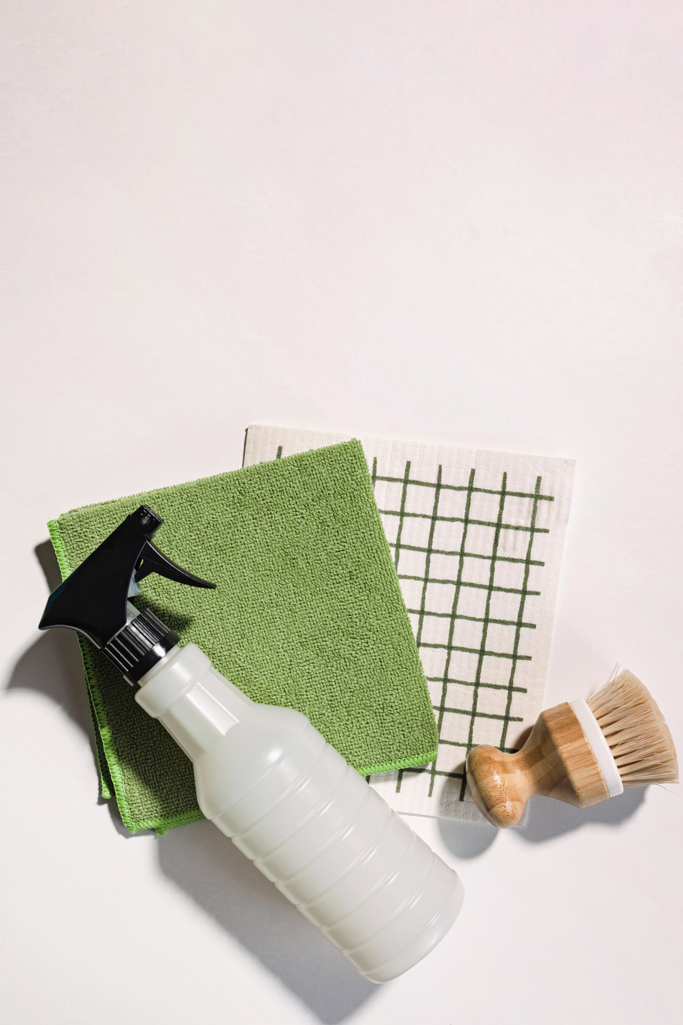 Cleaning supplies on white background, spray, brush and dishcloth, eco cleaning tools