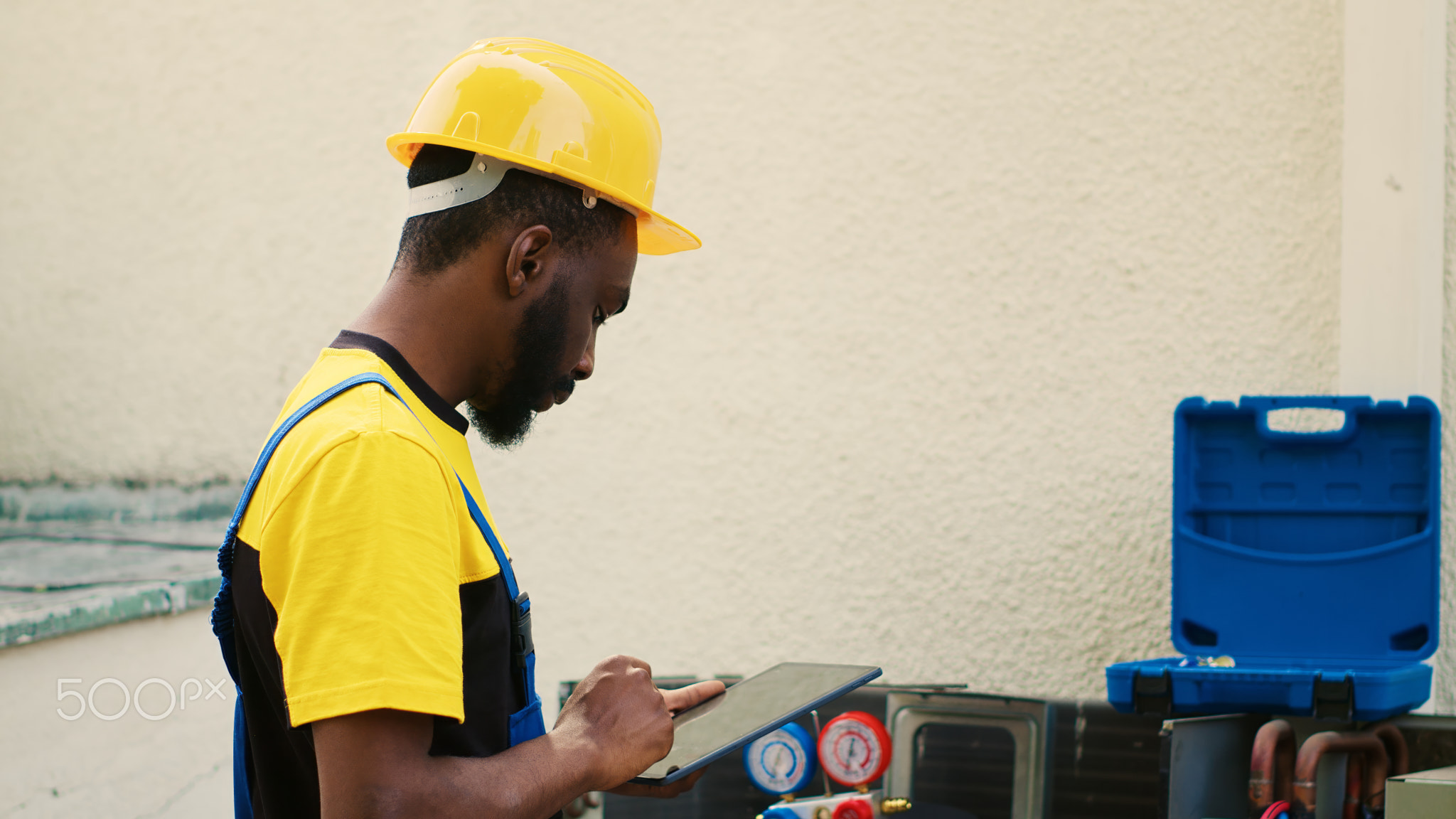 Happy technician using manifold meters