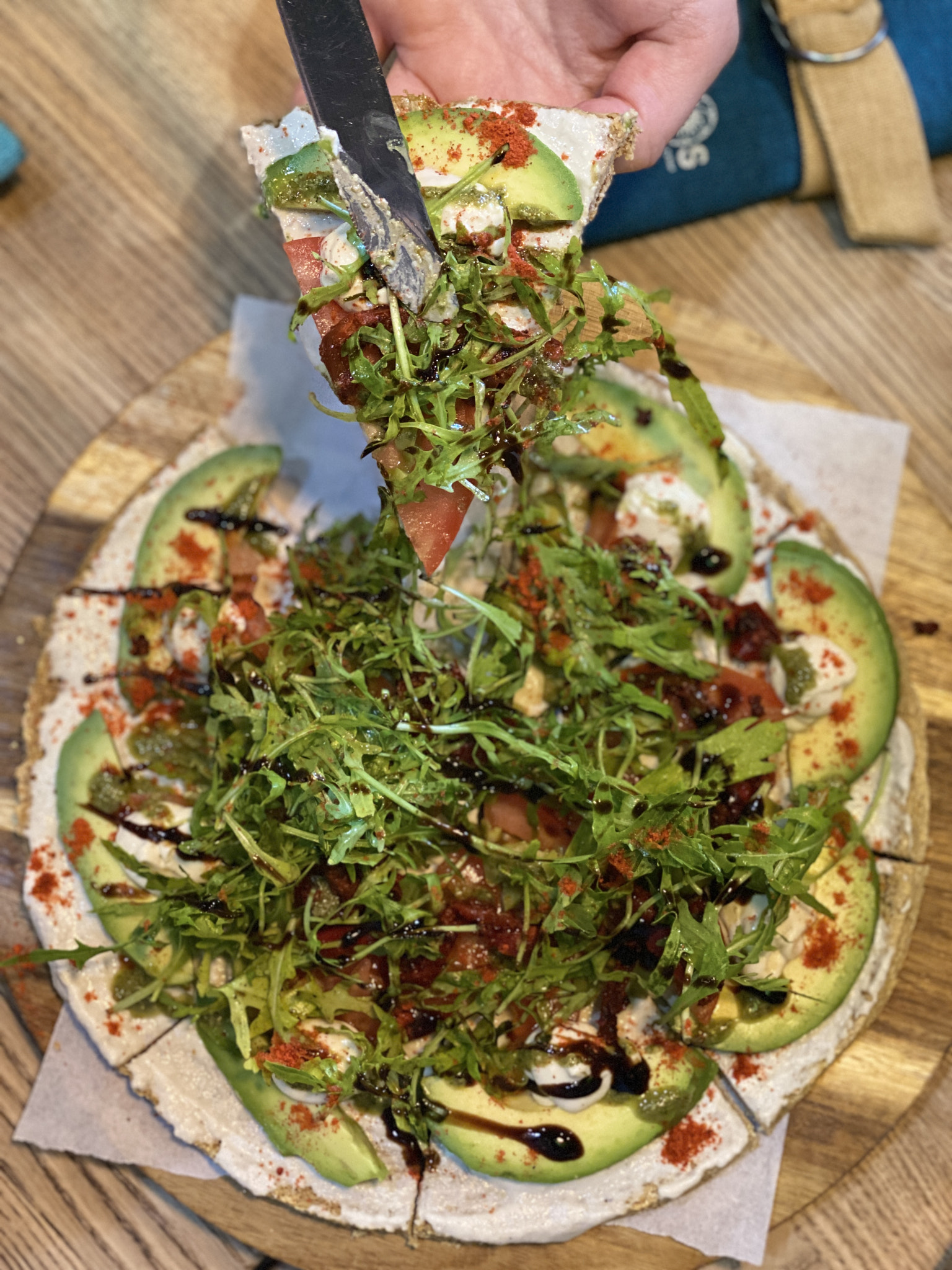 round vegan pizza with one slice top view