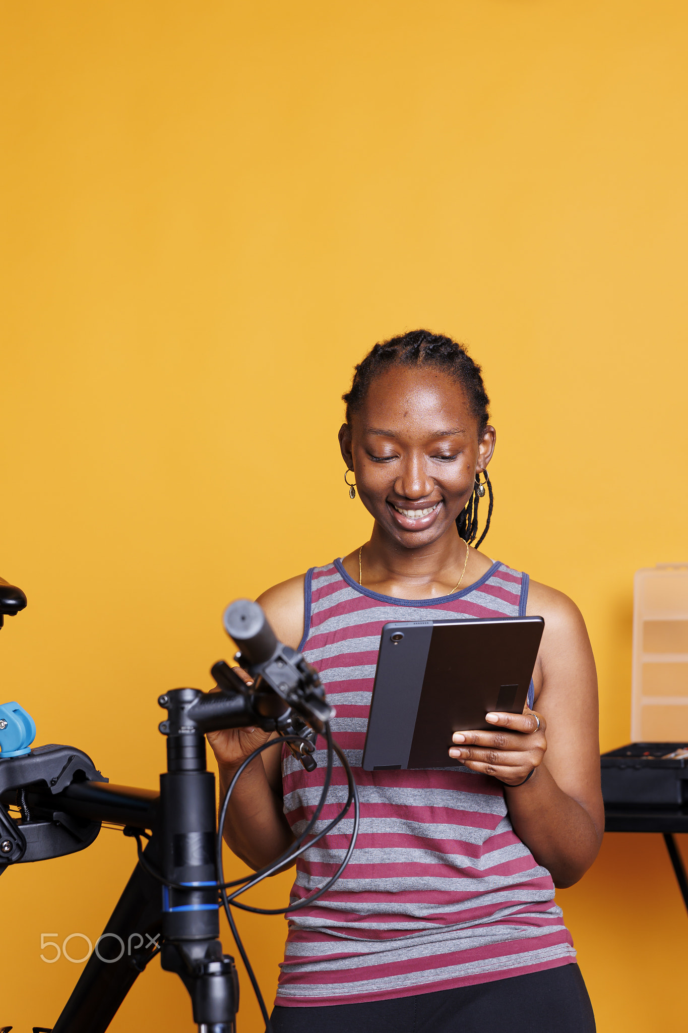 Woman with smart tablet for bike repair