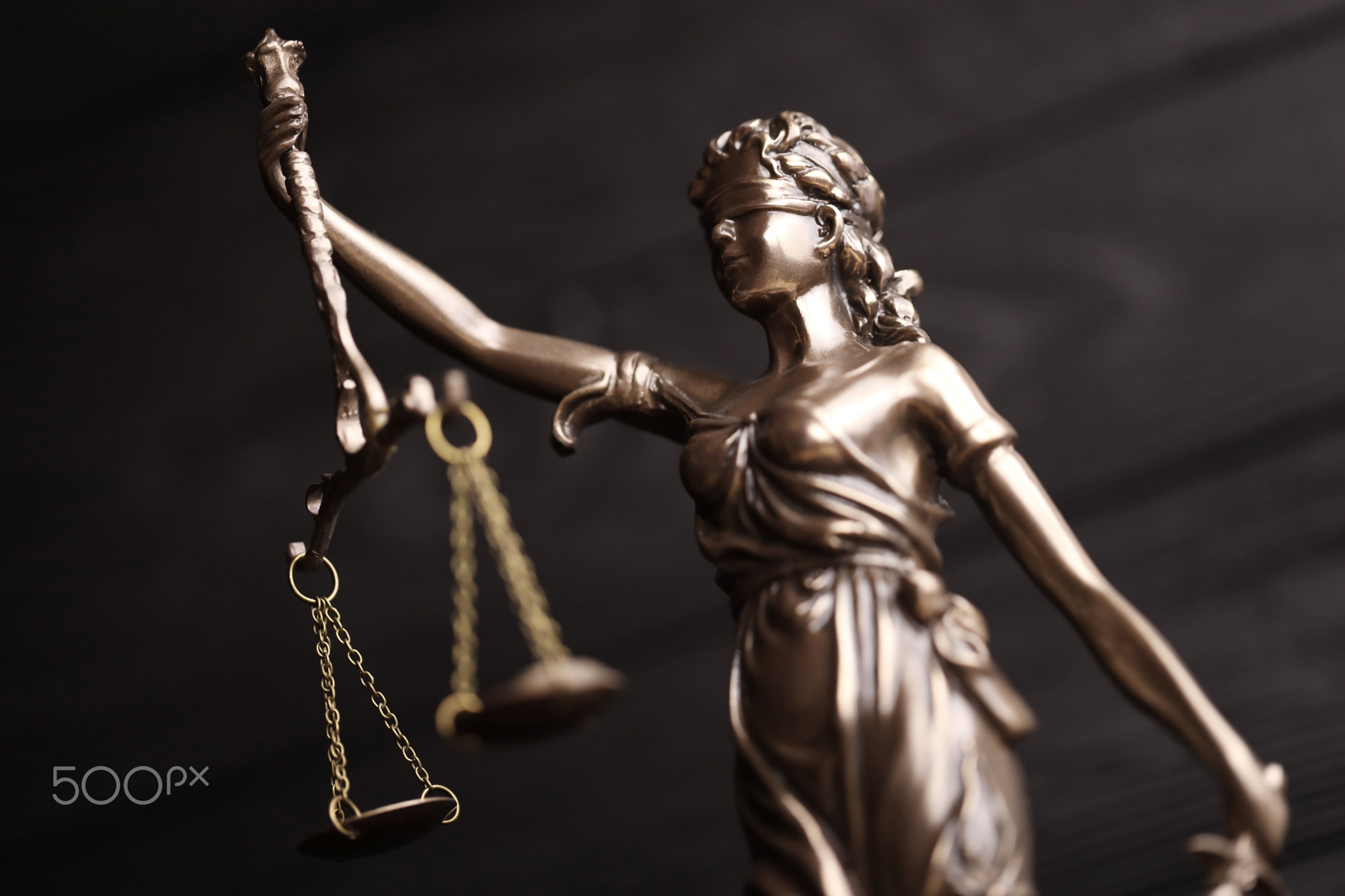 The Statue of Justice - lady justice or justitia the Roman goddess of Justice. Statue on black