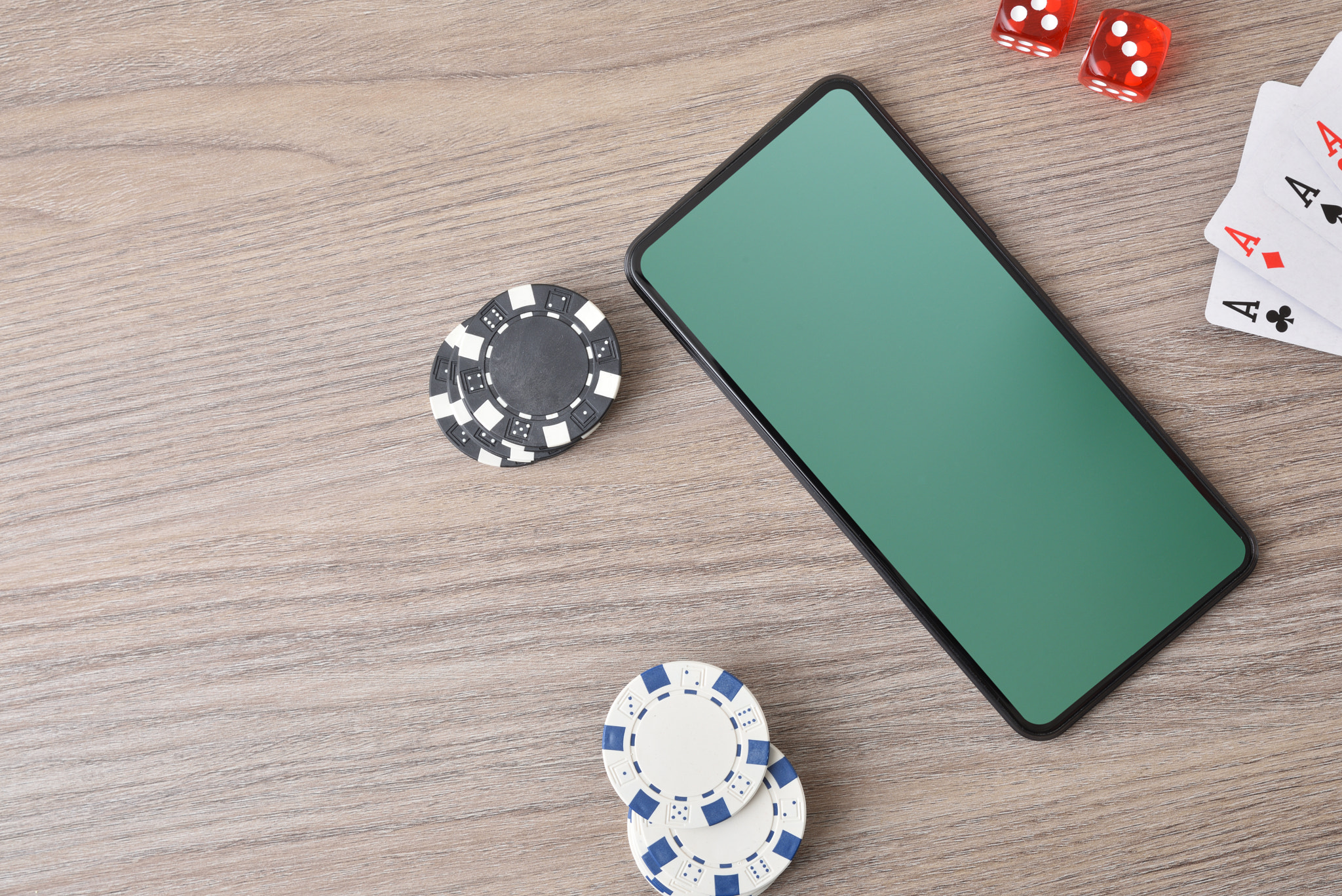 Virtual casino game with smartphone on table and objects around