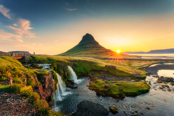 Sunrise over volcanic Kirkjufell mountain with waterfall flowing in summer by Thanayu Jongwattanasilkul on 500px.com