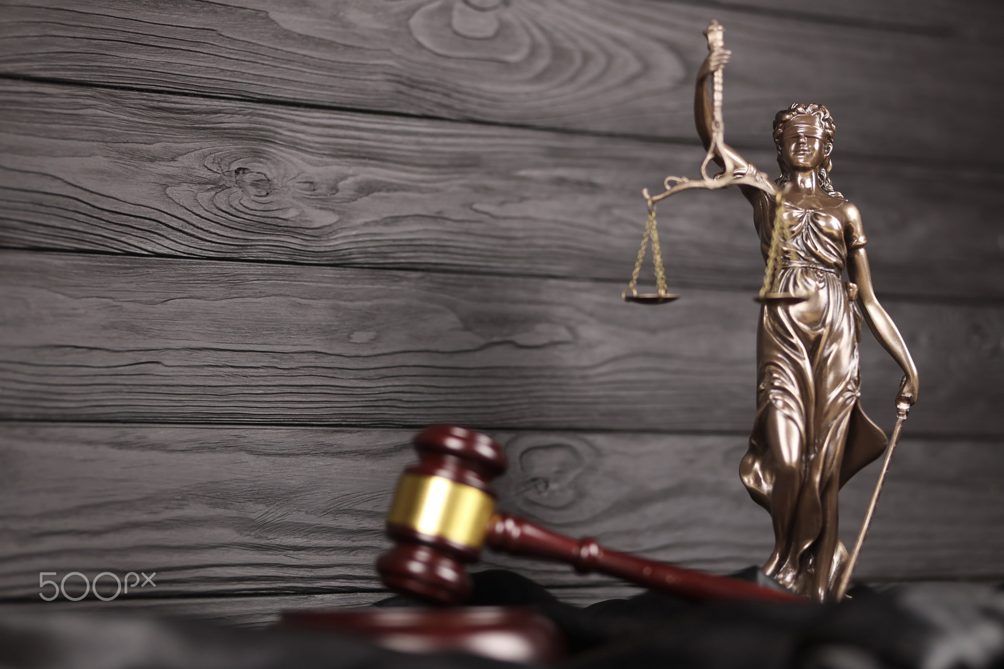 The Statue of Justice - lady justice or justitia the Roman goddess of Justice. Statue on brown book