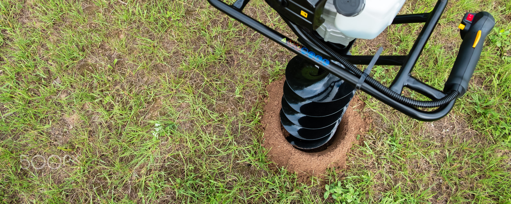 The drilled ground. The land hole. Borer for the fence installation