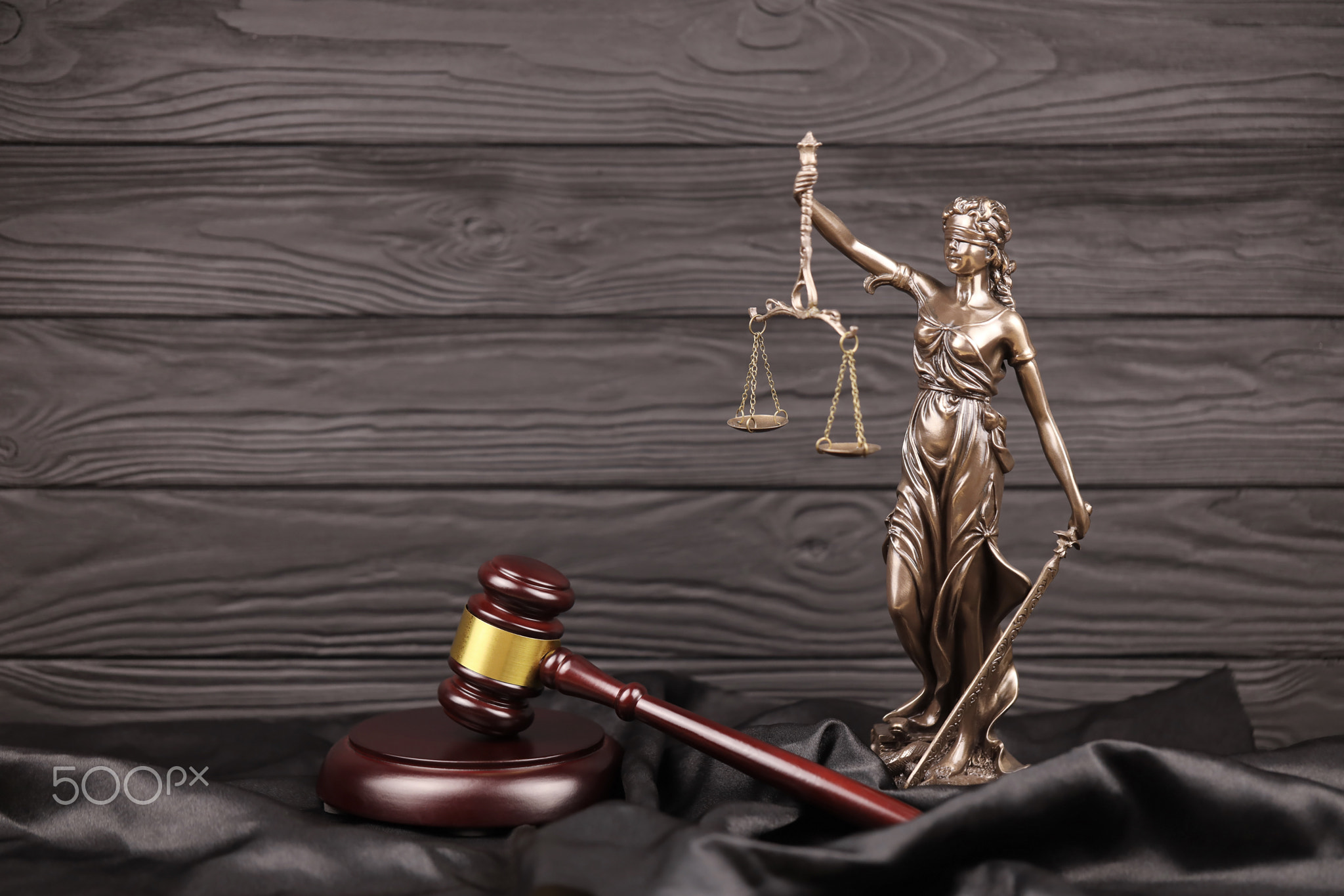 The Statue of Justice - lady justice or justitia the Roman goddess of Justice. Statue on brown book