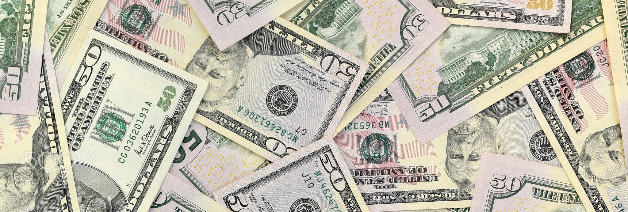 Many US fifty dollar bills on flat background surface close up. Flat lay top view. Abstract business