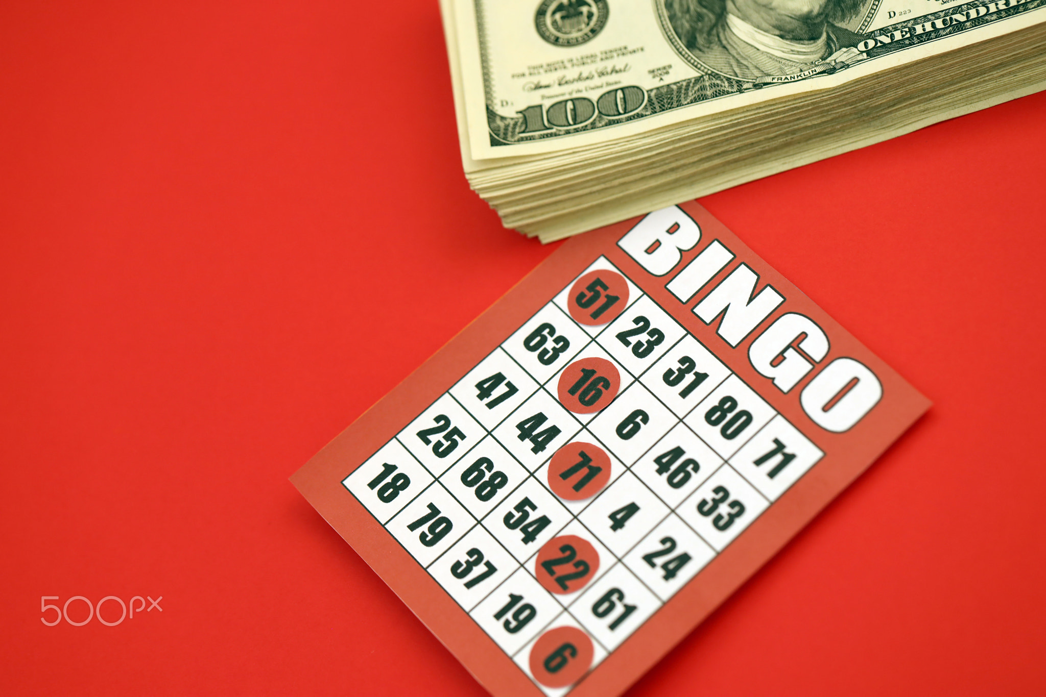 Red bingo board or playing card for winning chips and stack of dollar bills. Classic american or