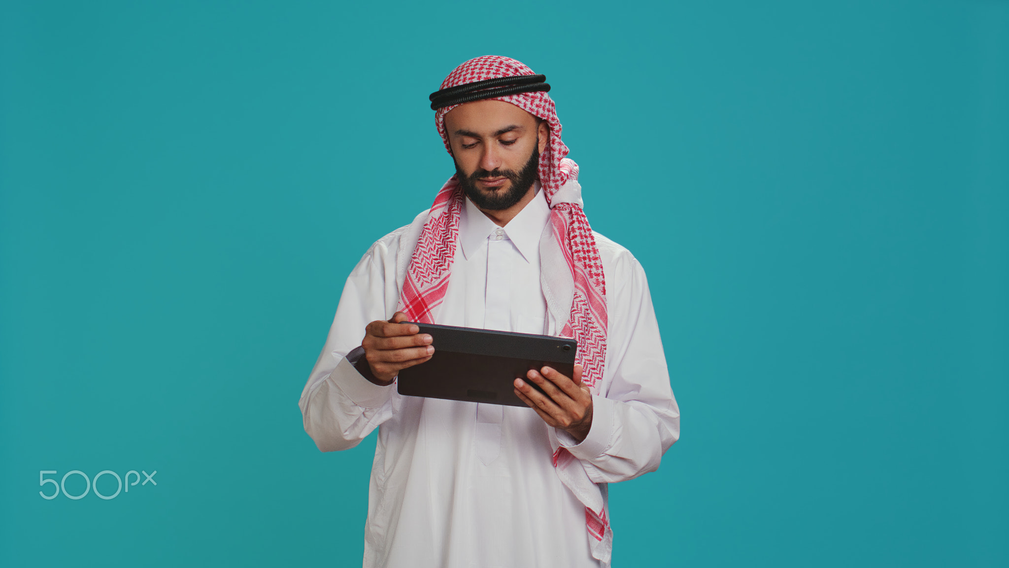 Middle eastern man checking tablet