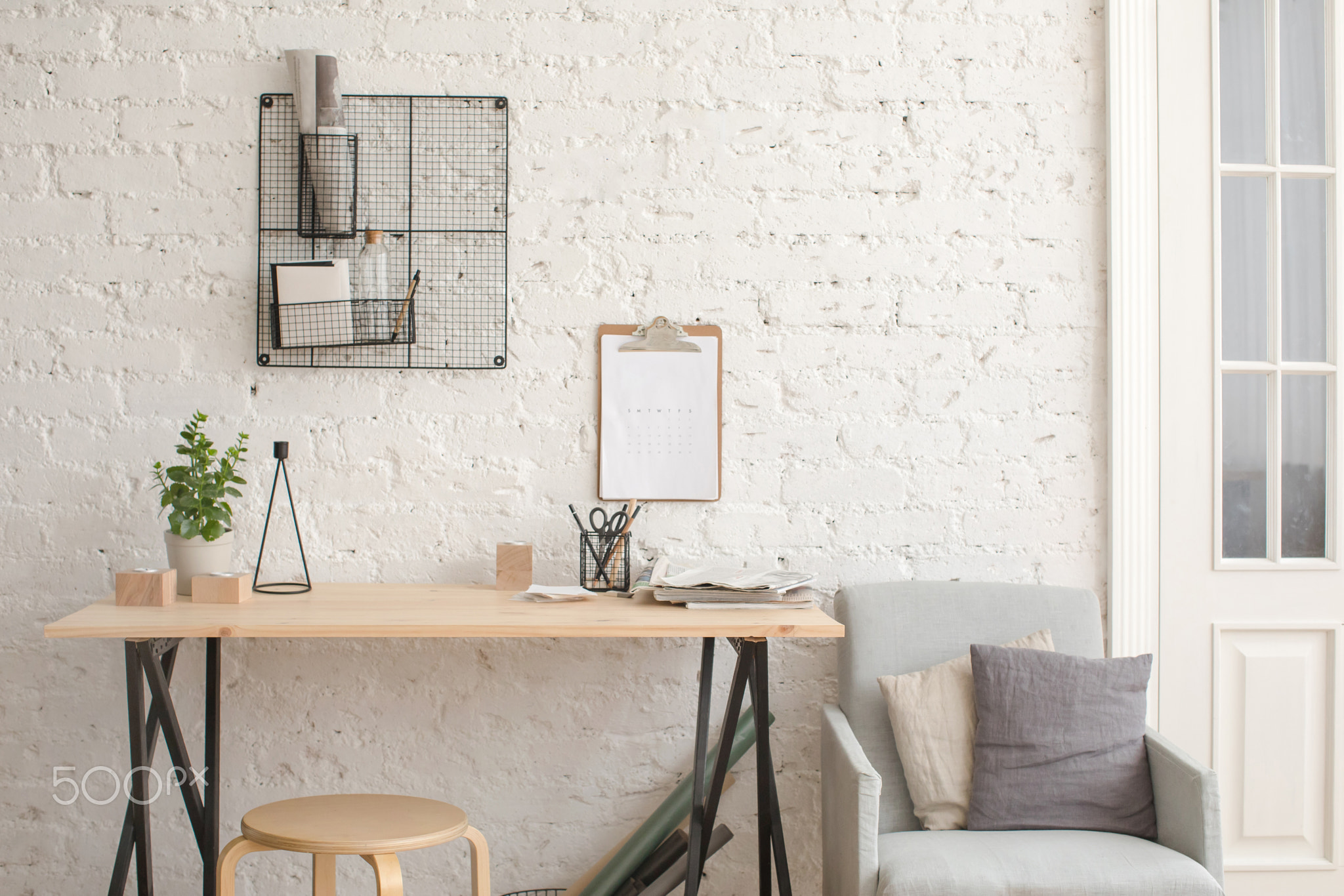 Desk with stationery in the white interior Loft