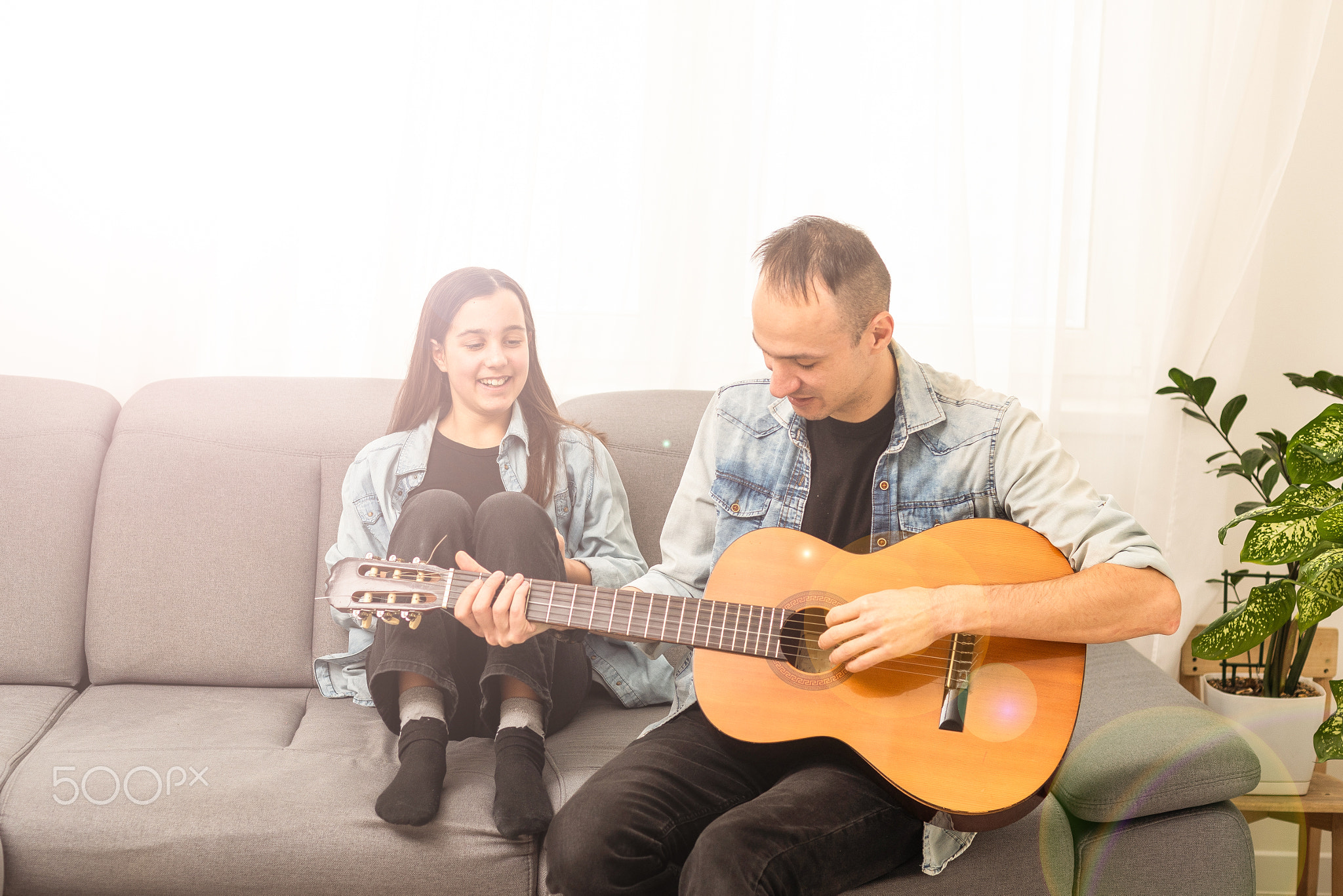 Artistic talented girl showing her latin music teacher the new song