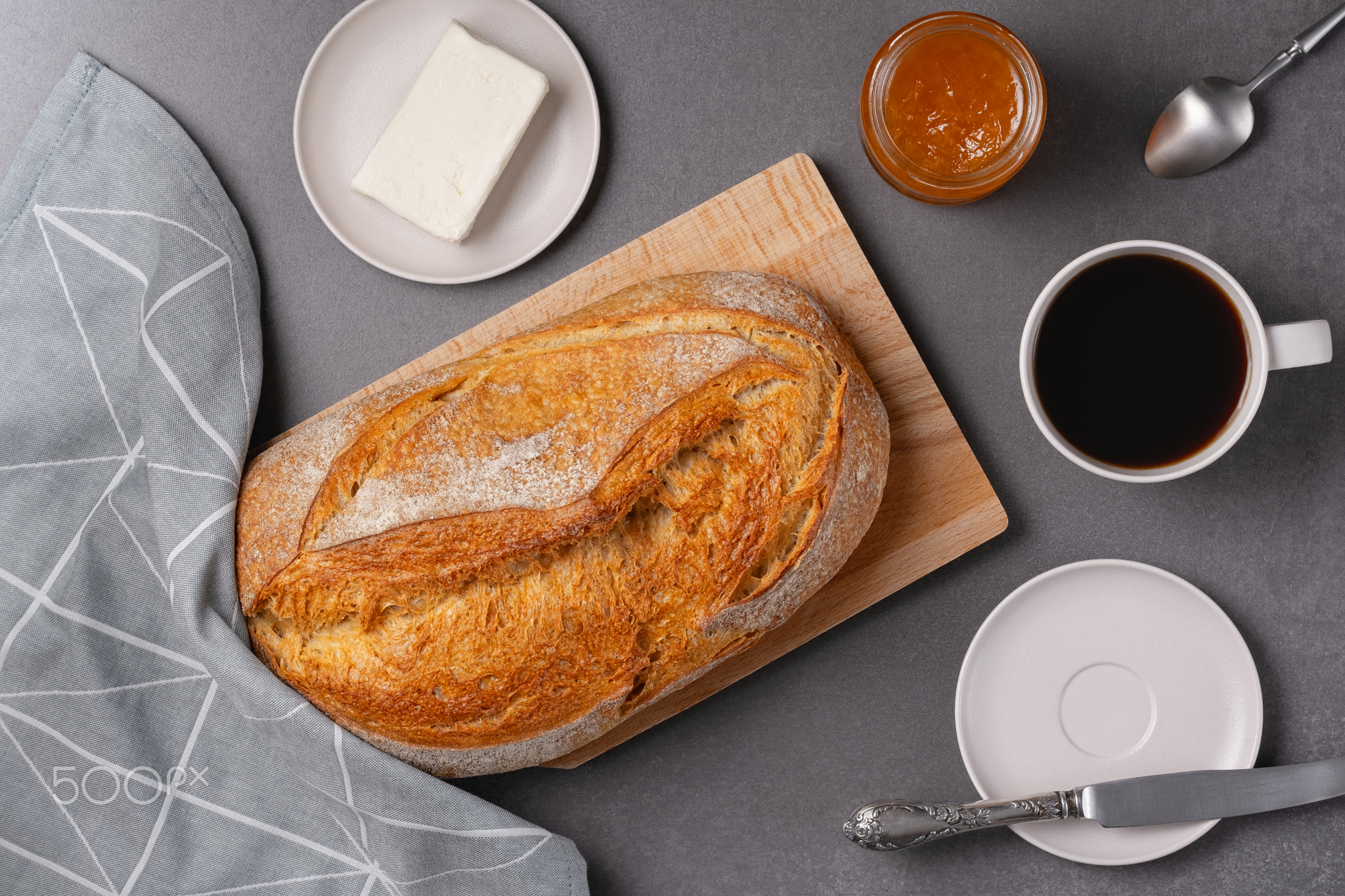Top view of bread, butter, jam and coffee