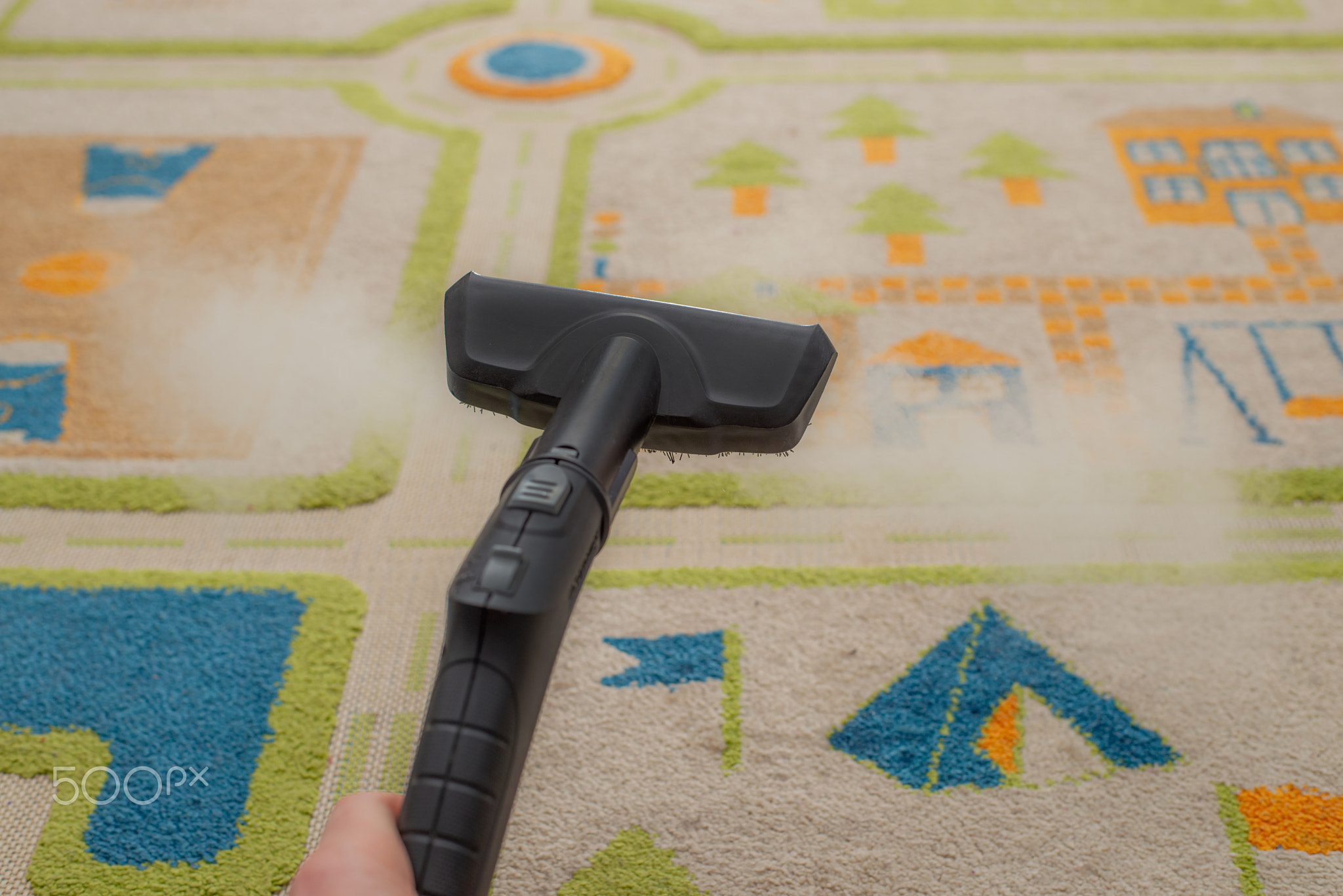 cleaning carpet with professional equipment in kids room, closeup