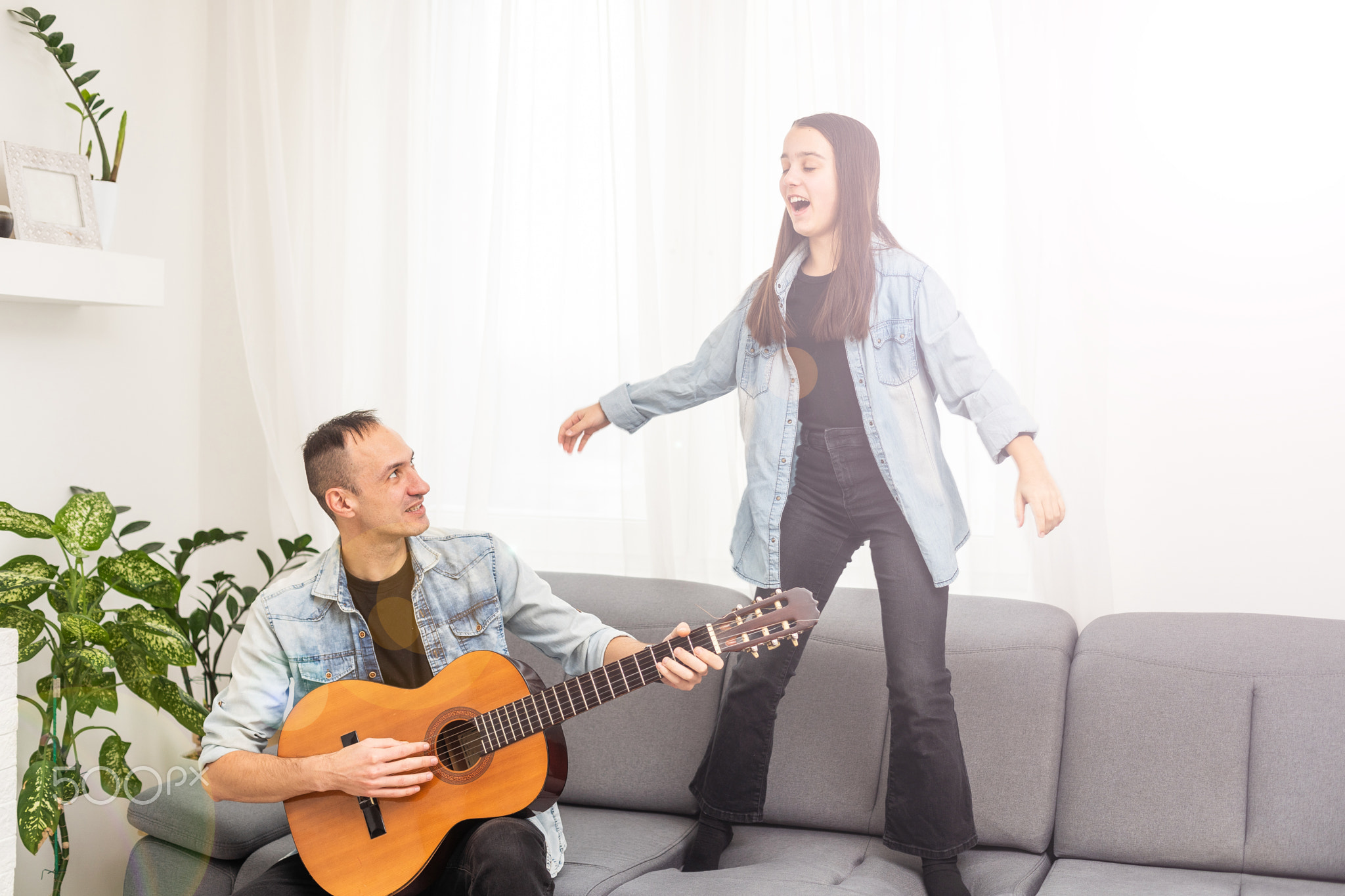 Guitar teacher teaching the little girl