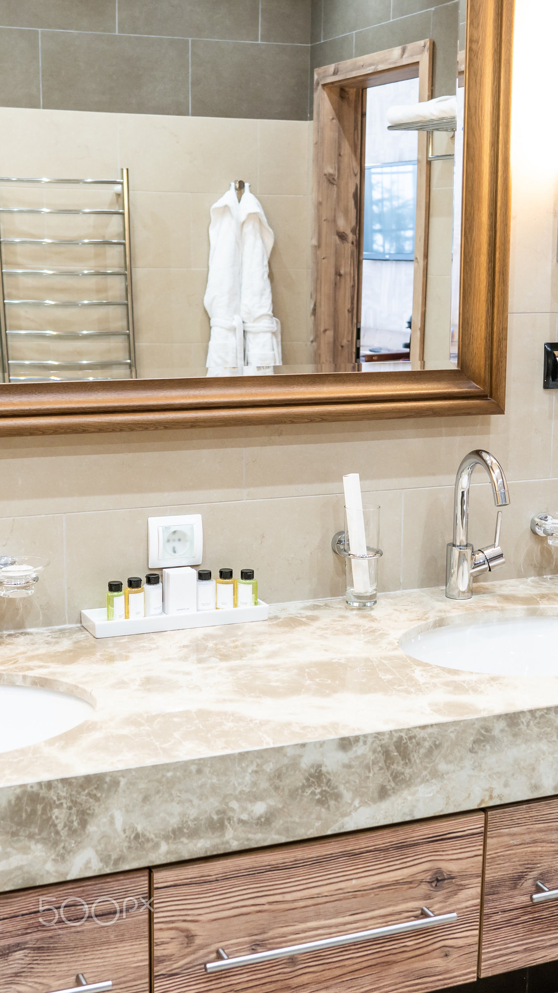 Luxury bathroom with brown tiles and two sinks