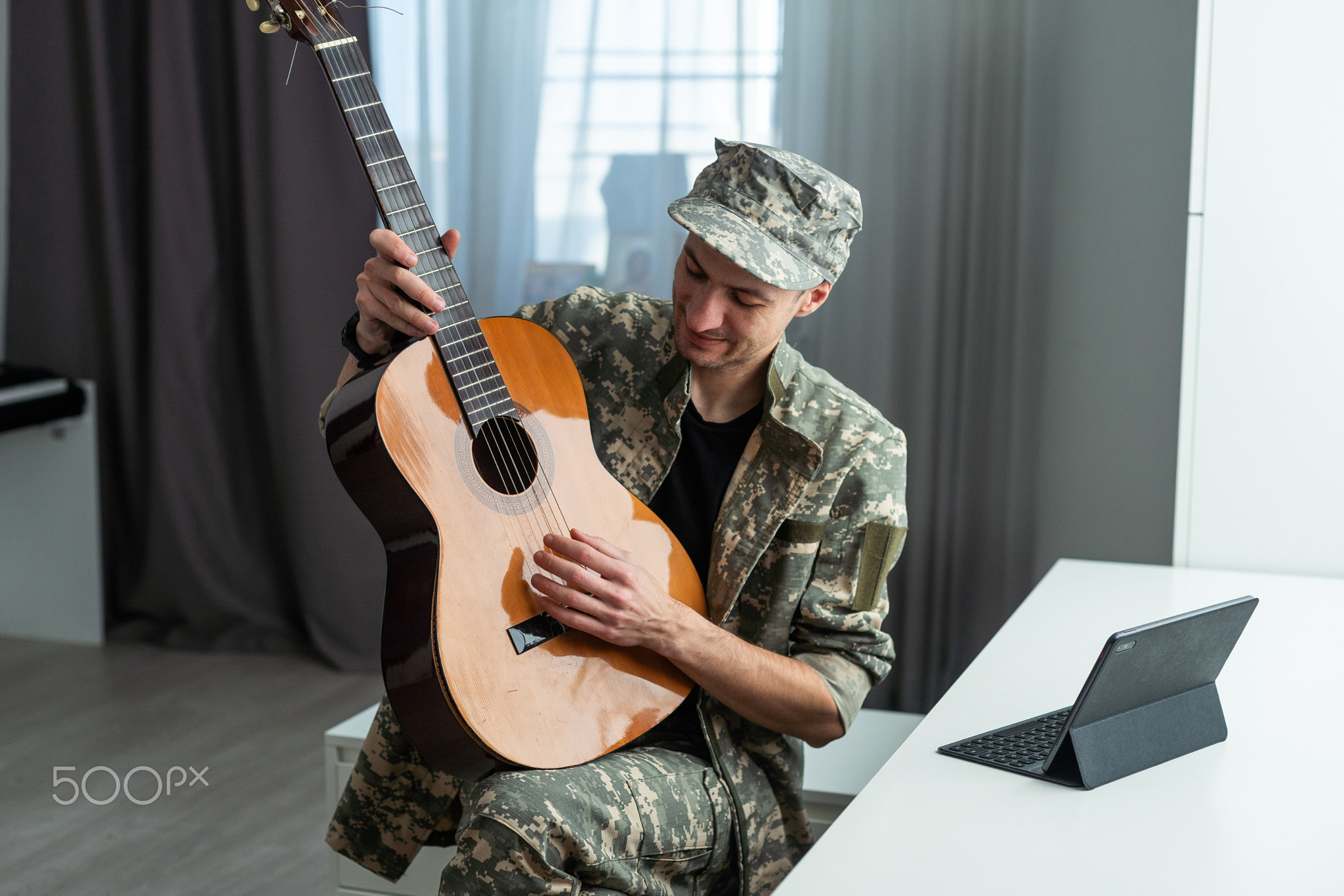 Veteran Guitar Play Concept. Family Meeting. Camouflage Uniform