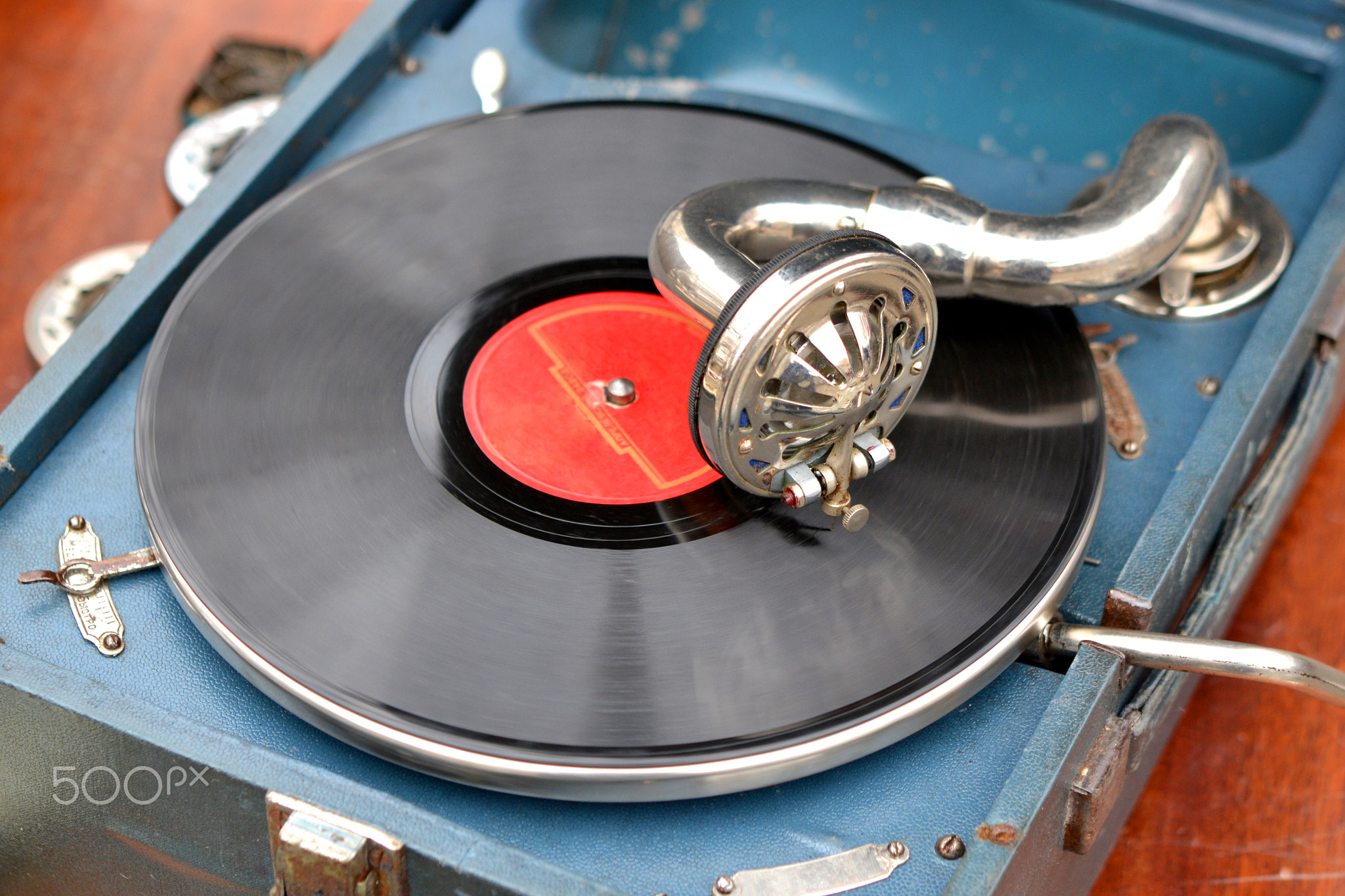 An old retro record playing on old vintage gramophone at flea market.