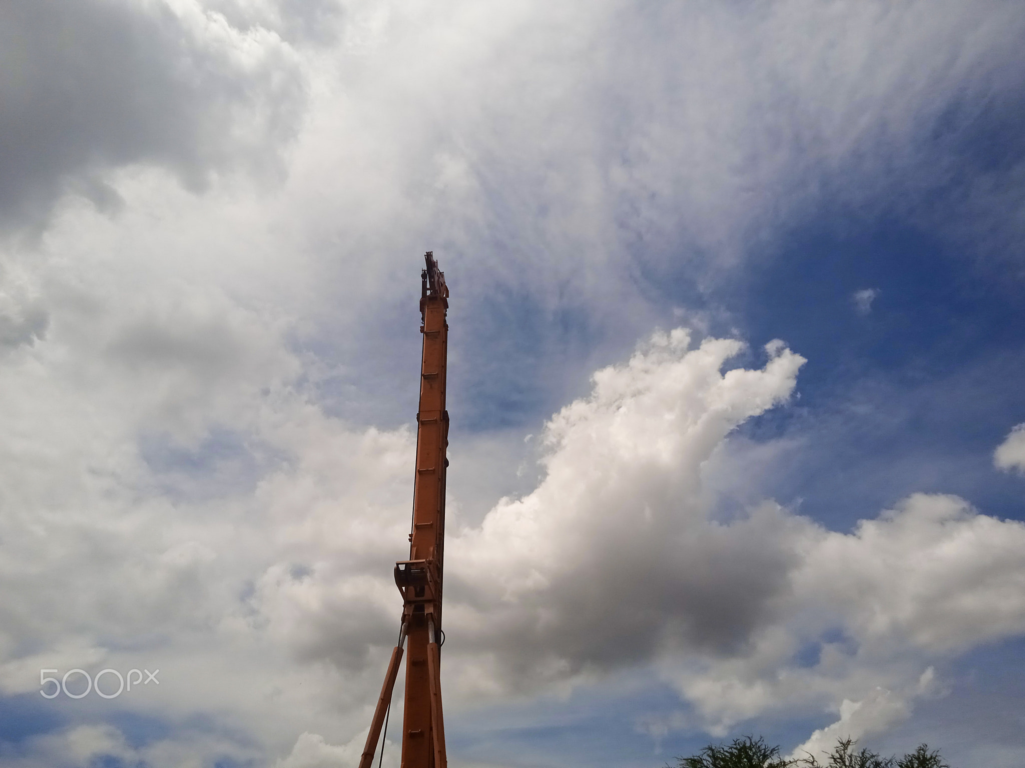 Heavy construction equipment with gloomy sky in the background
