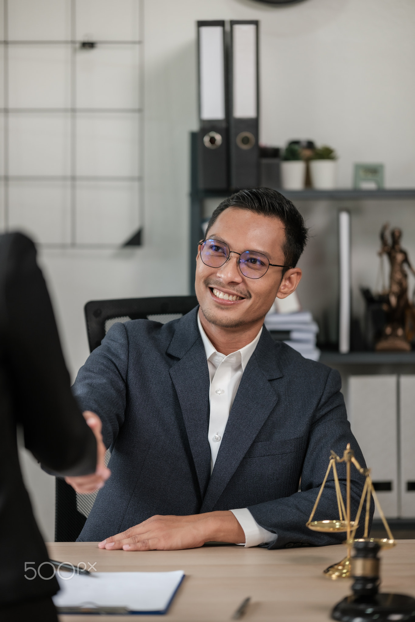 Asian lawyer man working on table office Writing a document, law and justice concept.