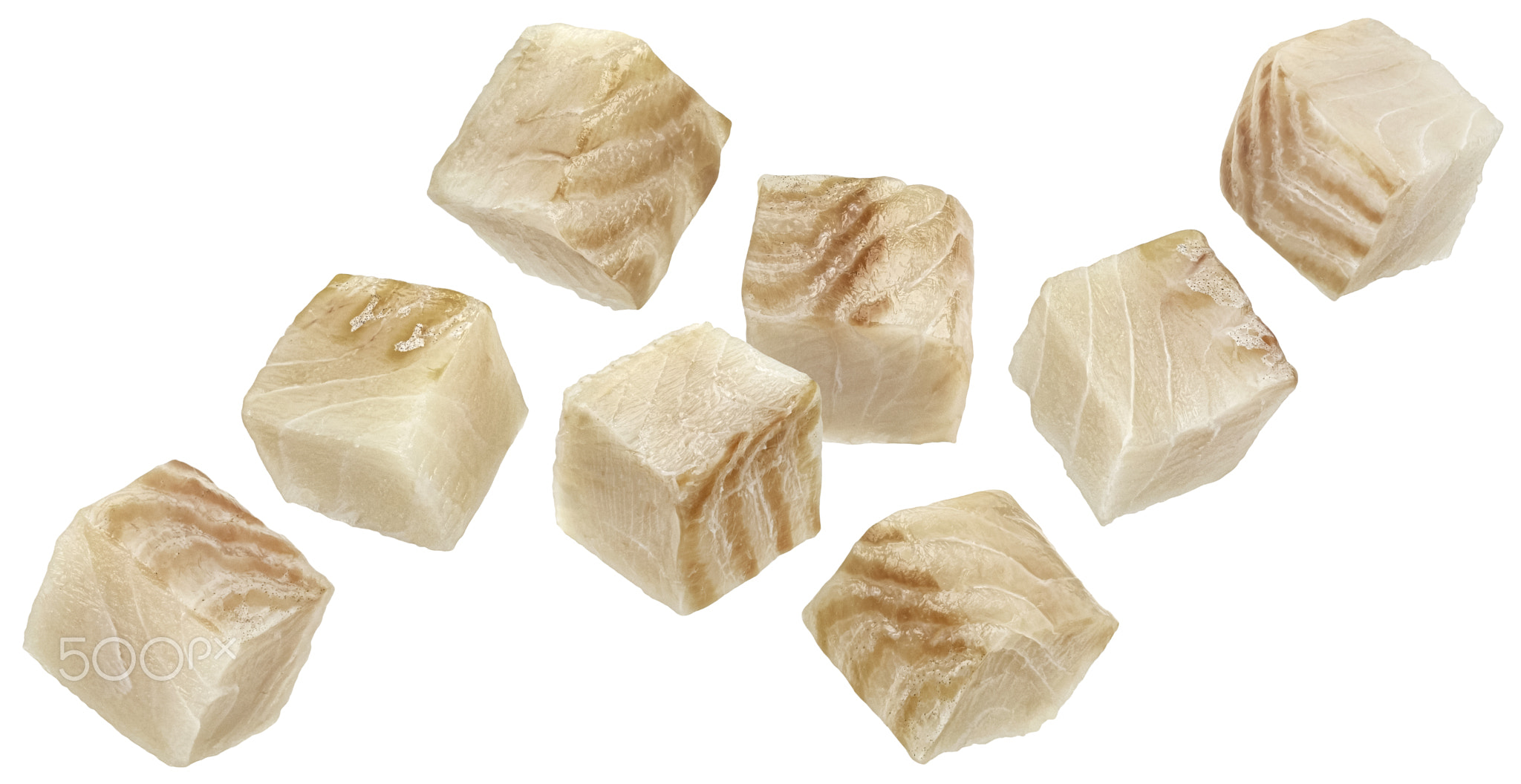 Falling cod fish fillet cubes isolated on white background