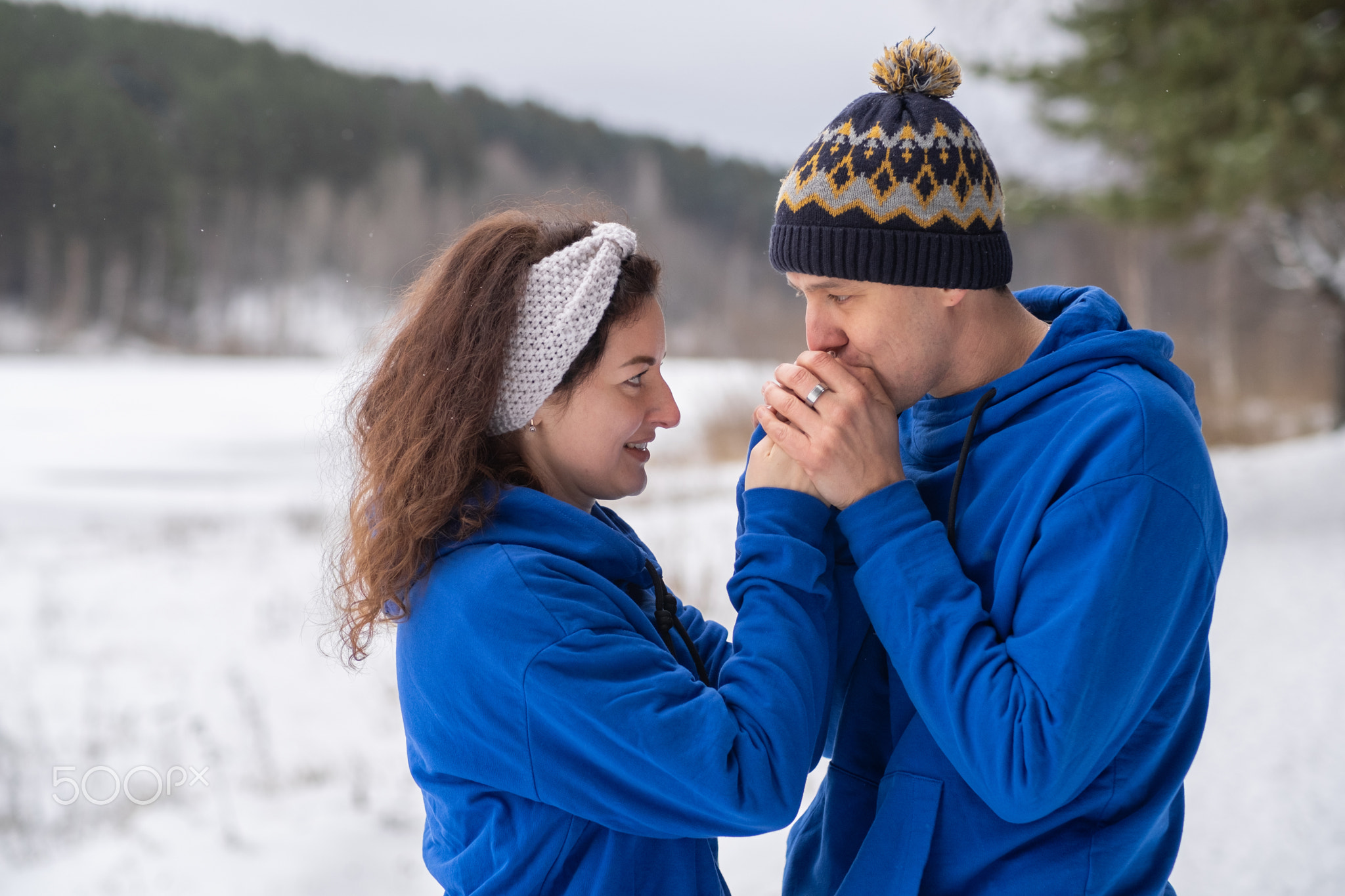 Outdoor happy couple in love posing in cold winter weather.