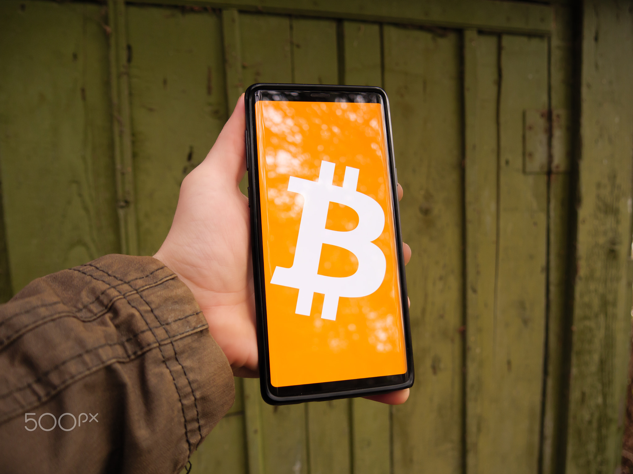 Bitcoin symbol displayed on a smartphone screen. BTC