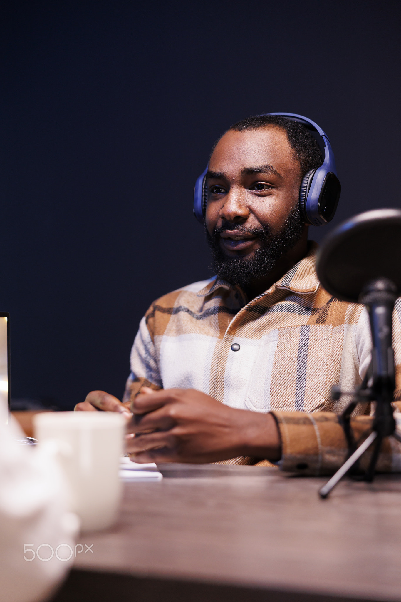 Black man recording a podcast at home