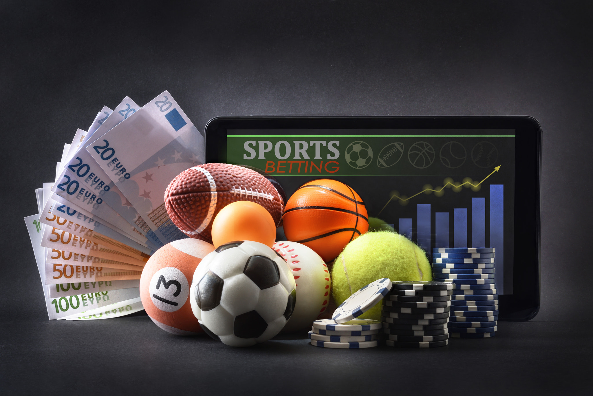 Sports betting with representative objects with money and tablet