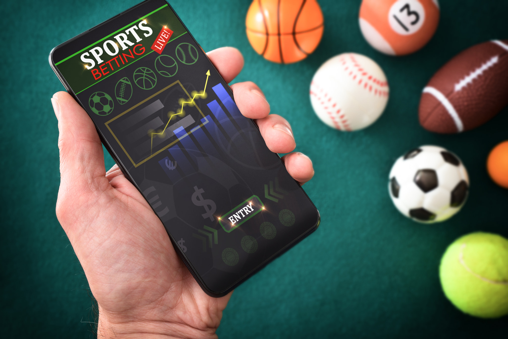 Person consulting online sports information in an app and balls