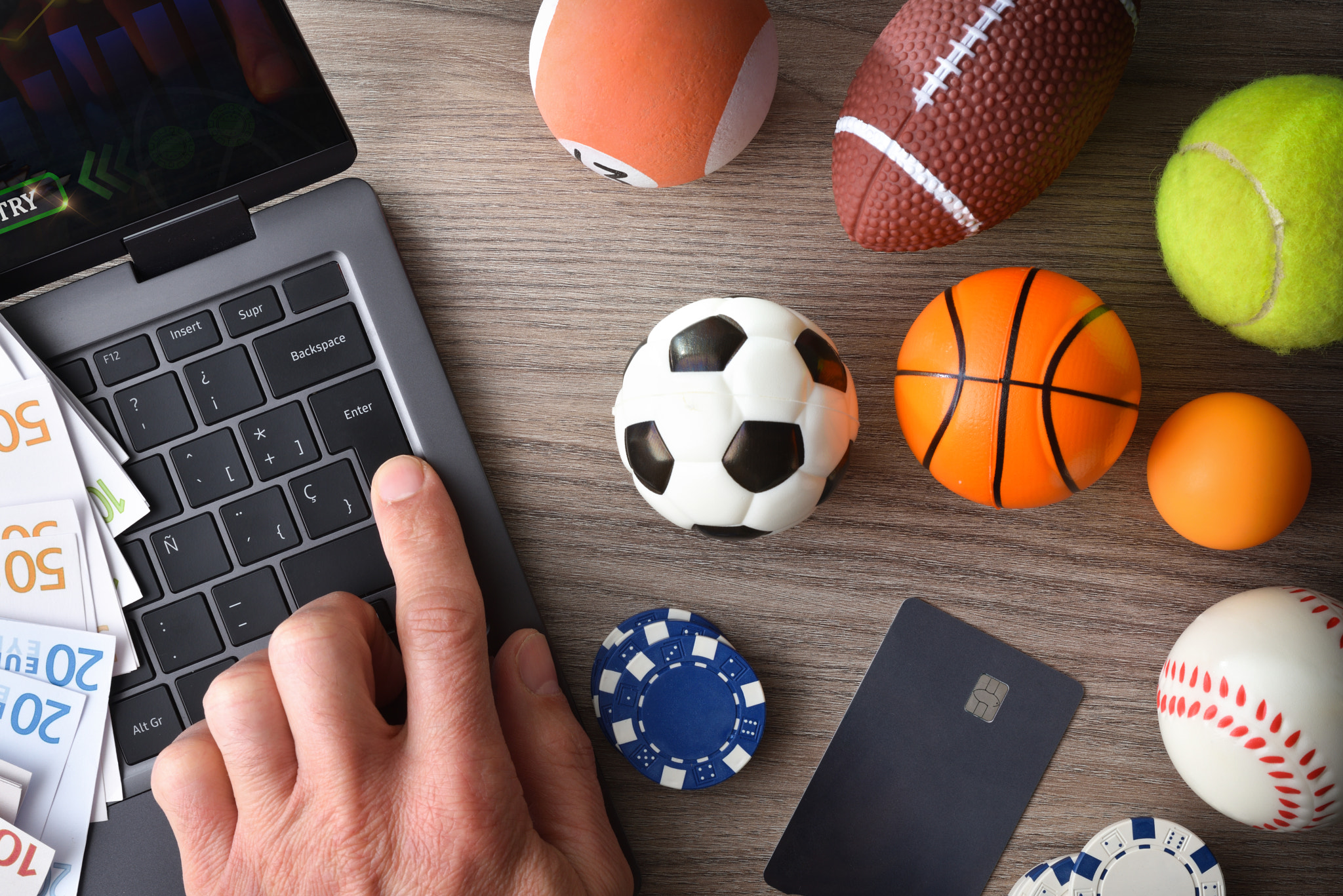 Person accessing an online sports betting platform on a laptop