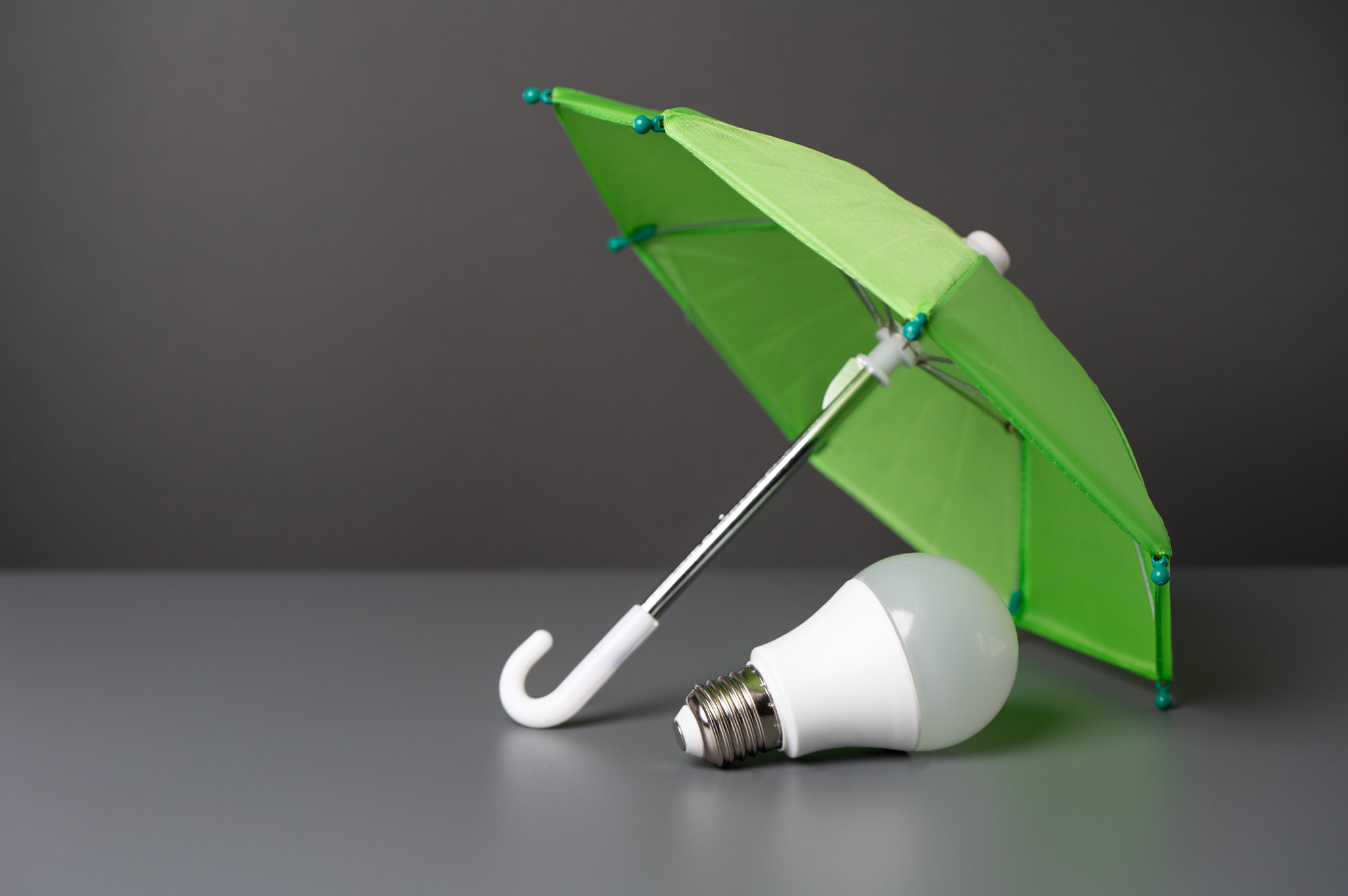 A light bulb idea under the insurance umbrella. Innovative solutions. Business insurance. Protection