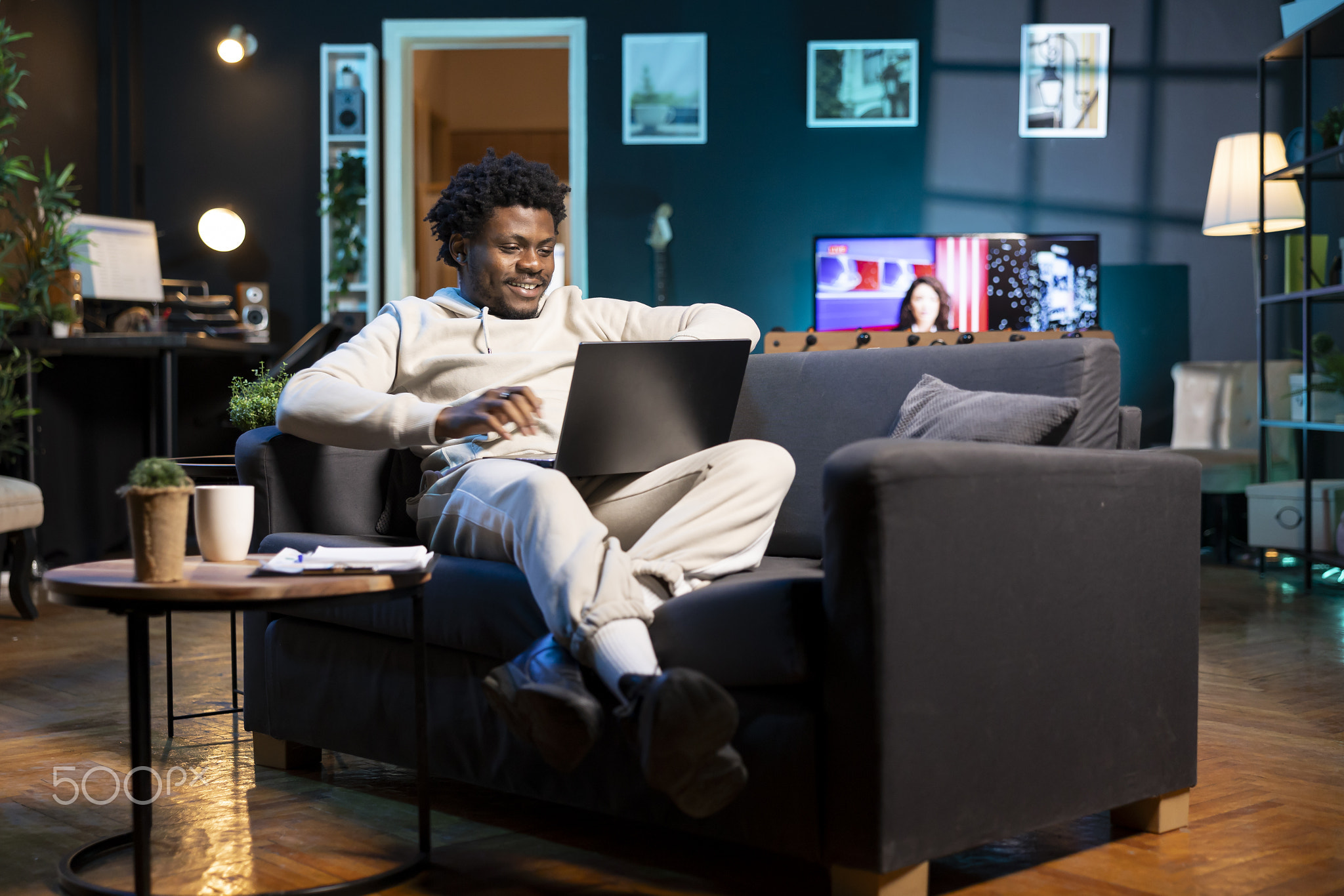 Cheerful remote worker checking his emails on laptop