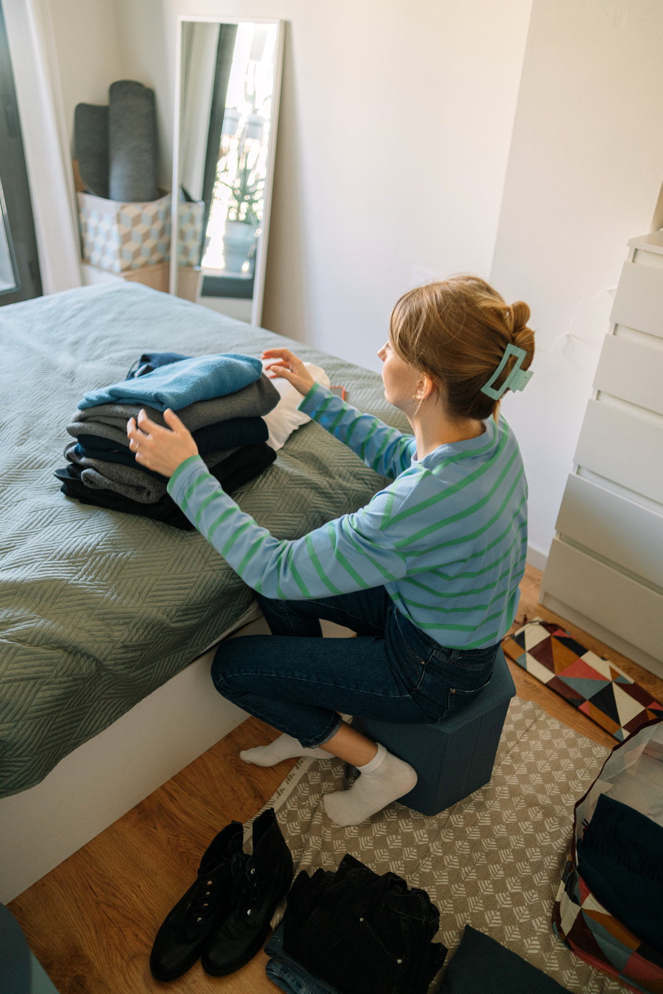 Young woman packing a suitcase