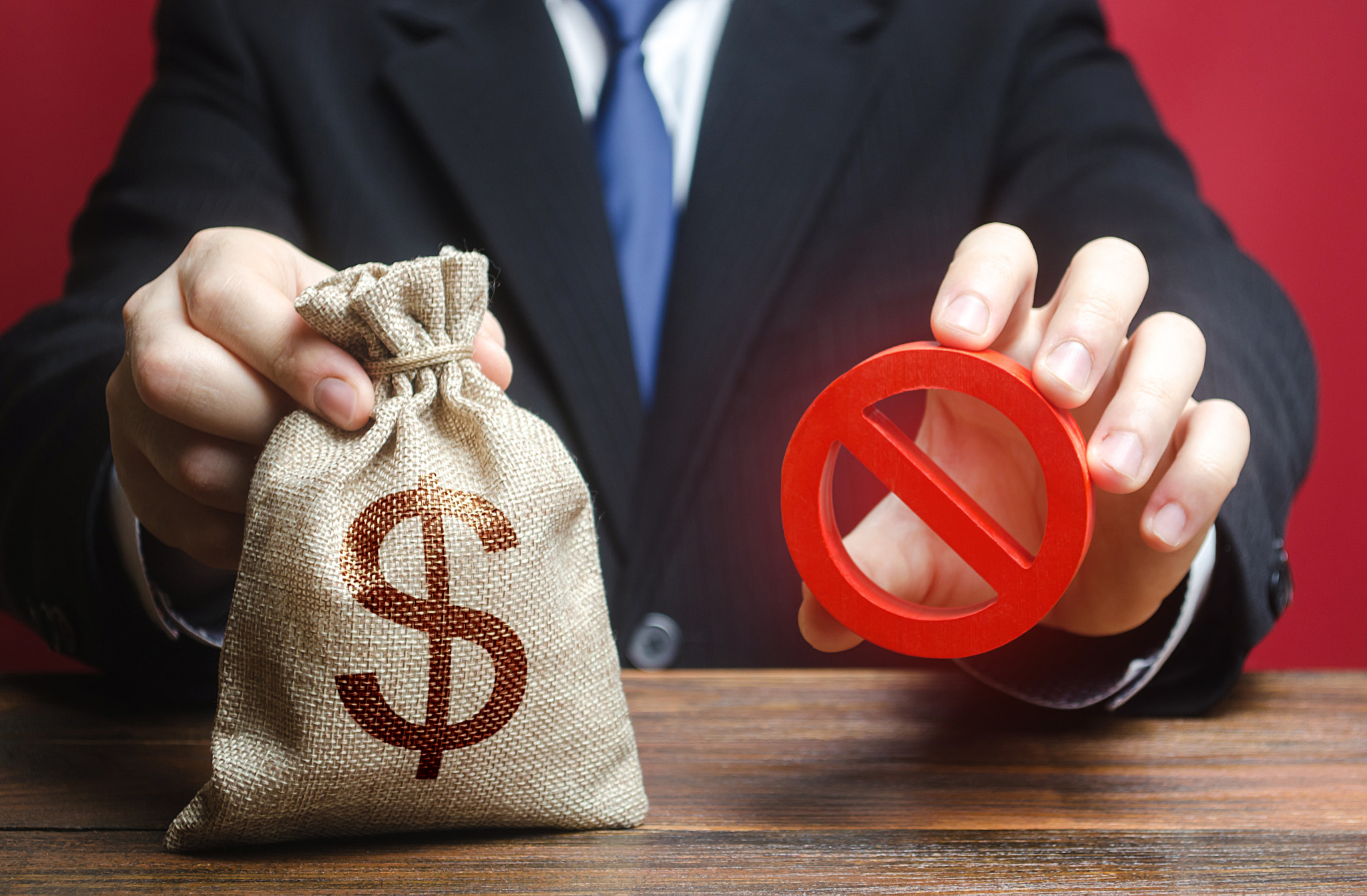 Businessman refuses to give a money bag. Denial of cooperation. Refusal to grant loan mortgage, bad 