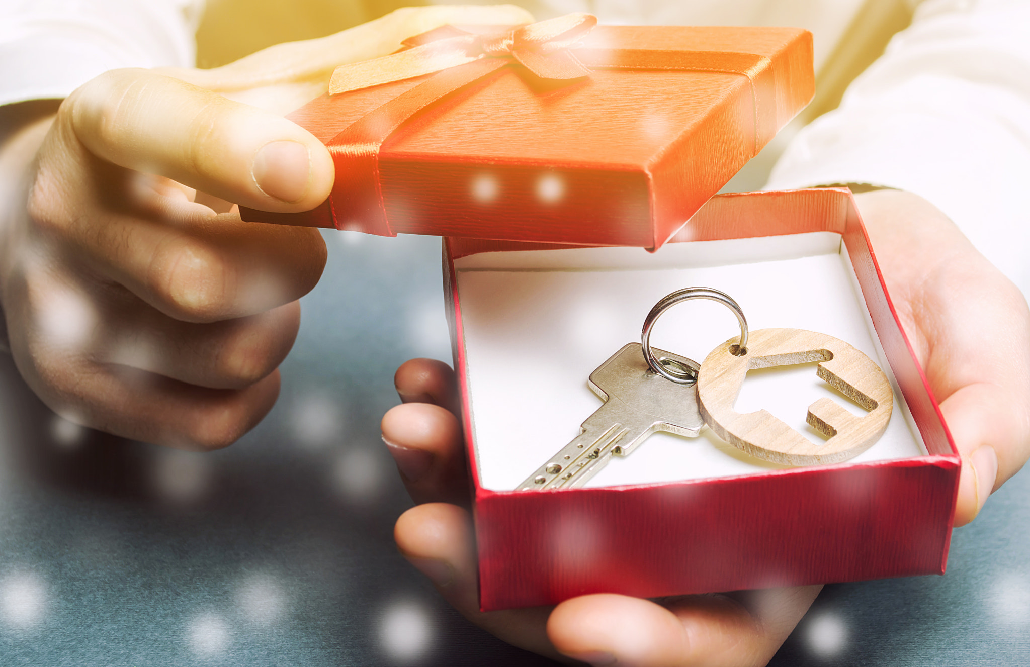 Keys with a house with a gift box and snow. Great offers for real estate in the winter season. Disco